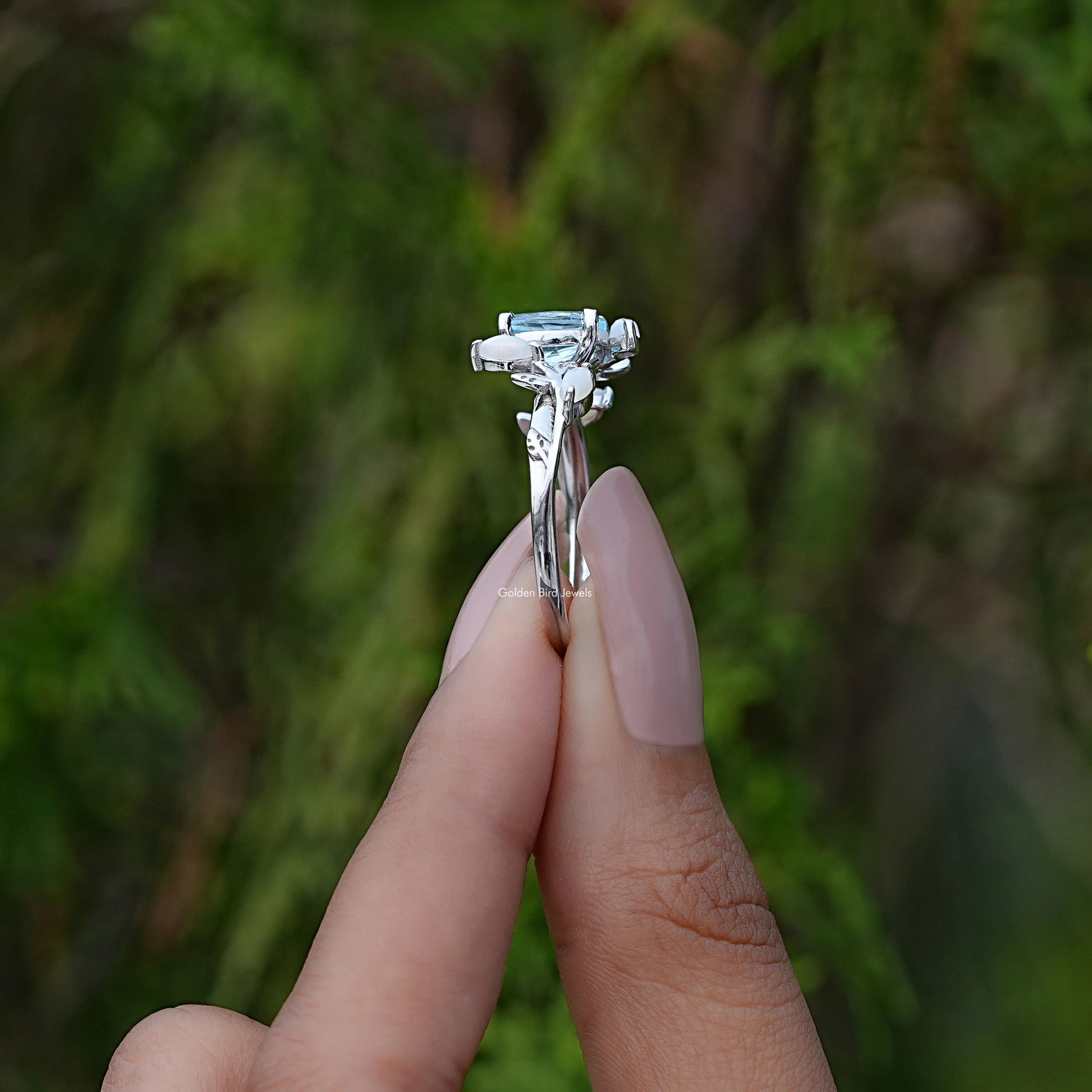 Side View of Oval Cut Shaped Leaf Style Accent Ring In two fingers