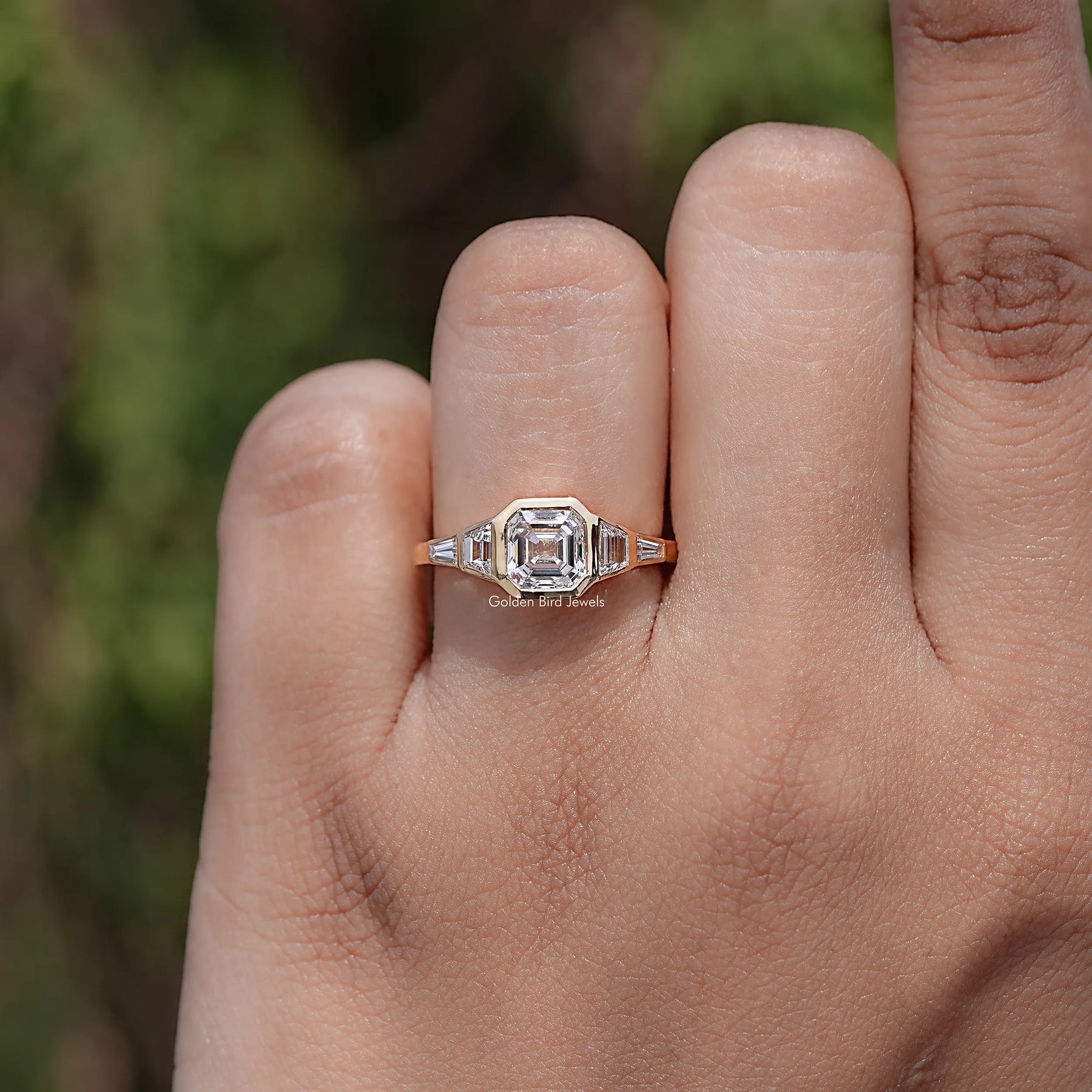 Top view of Princess Diamond Five Stone Engagement Ring held in finger