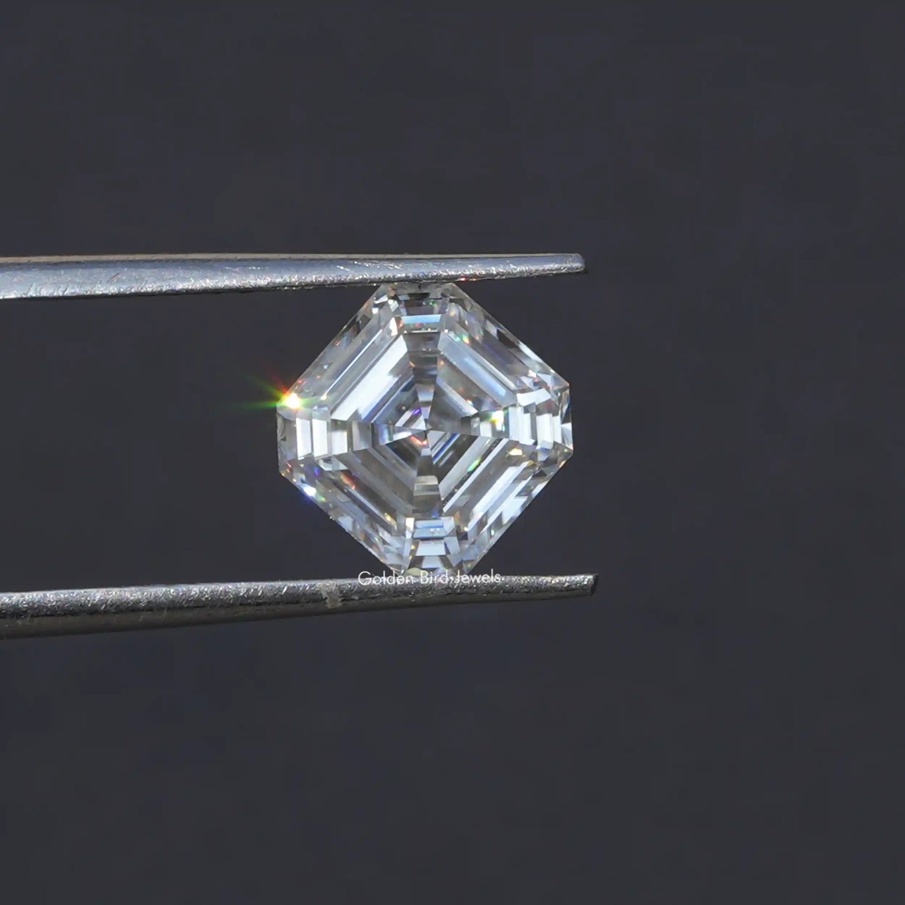 Tweezer holding the  Moissanite Asscher Cut Loose Stone
