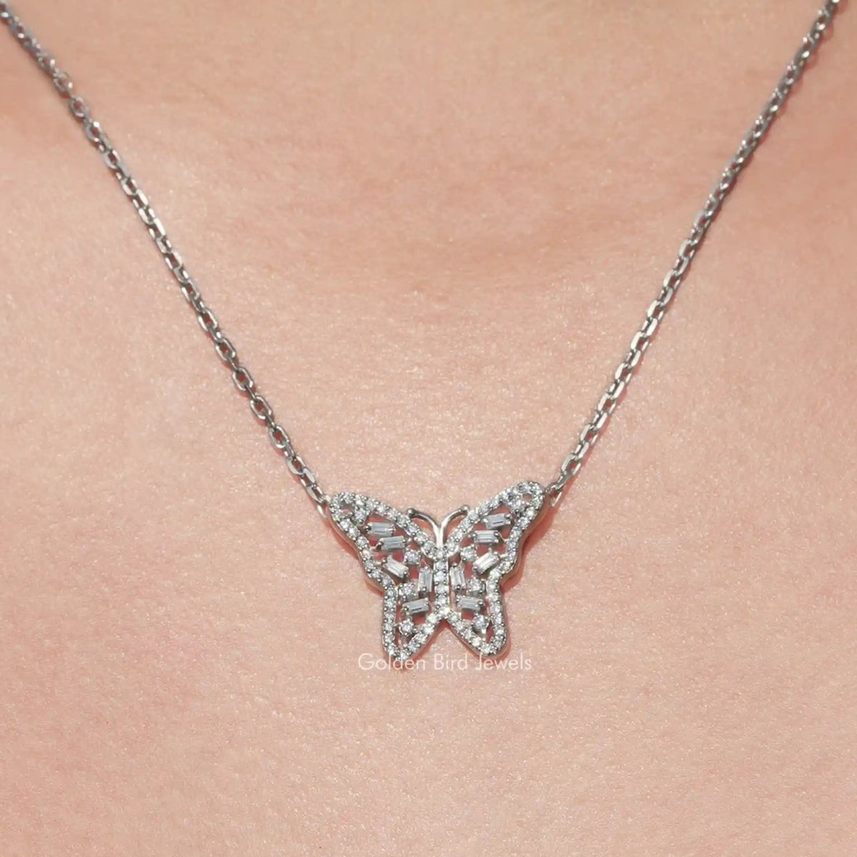 View of colorless butterfly round cut moissanite pendant