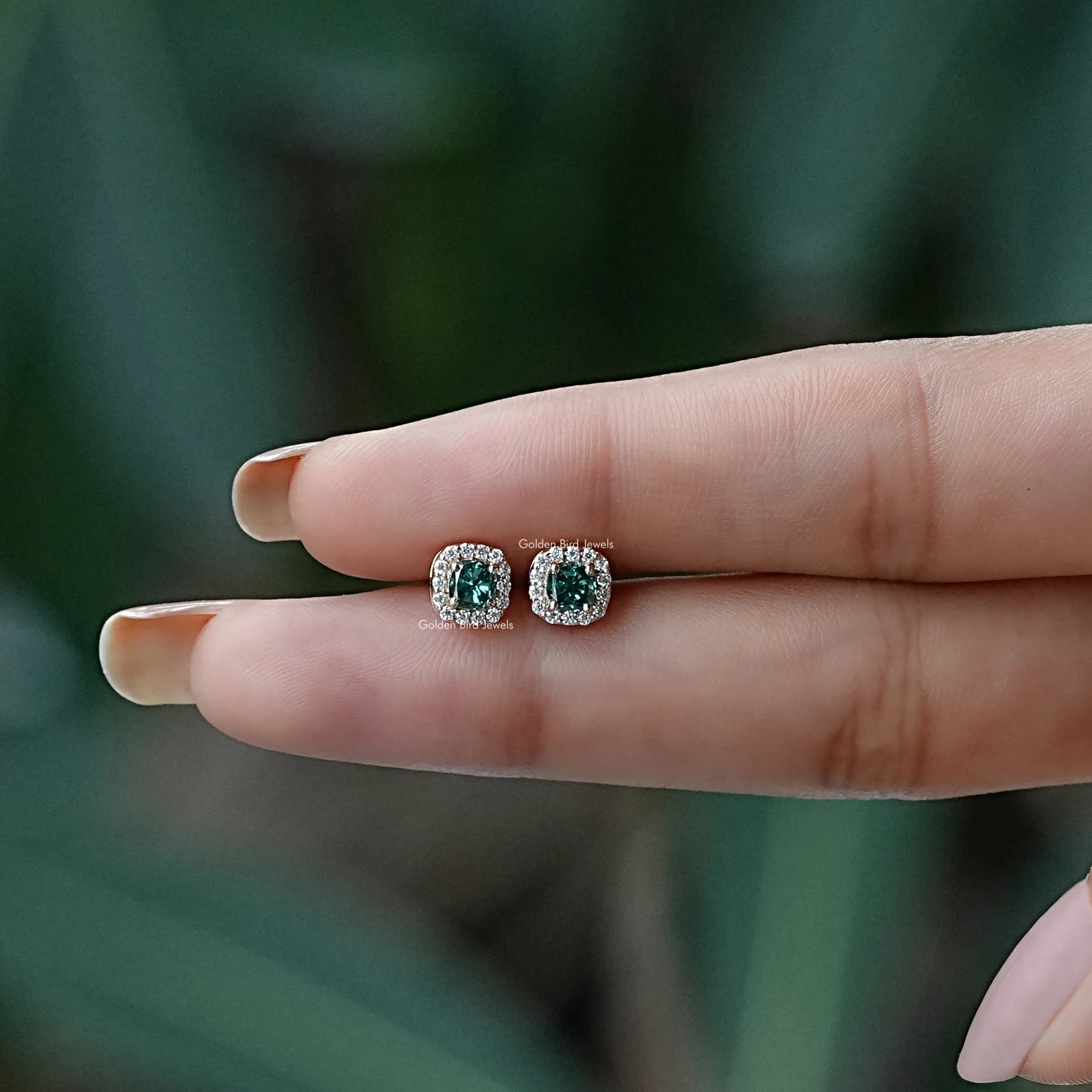 In two finger view of Stud earrings crafted in moissanite
