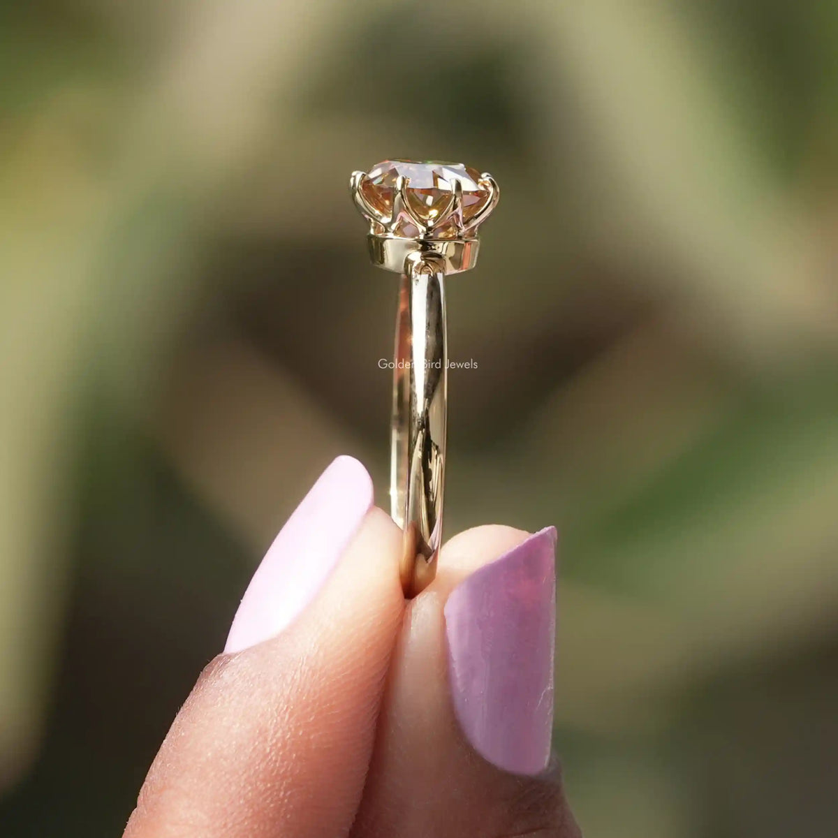 Side View of Round Cut Moissanite Solitaire Ring In two fingers