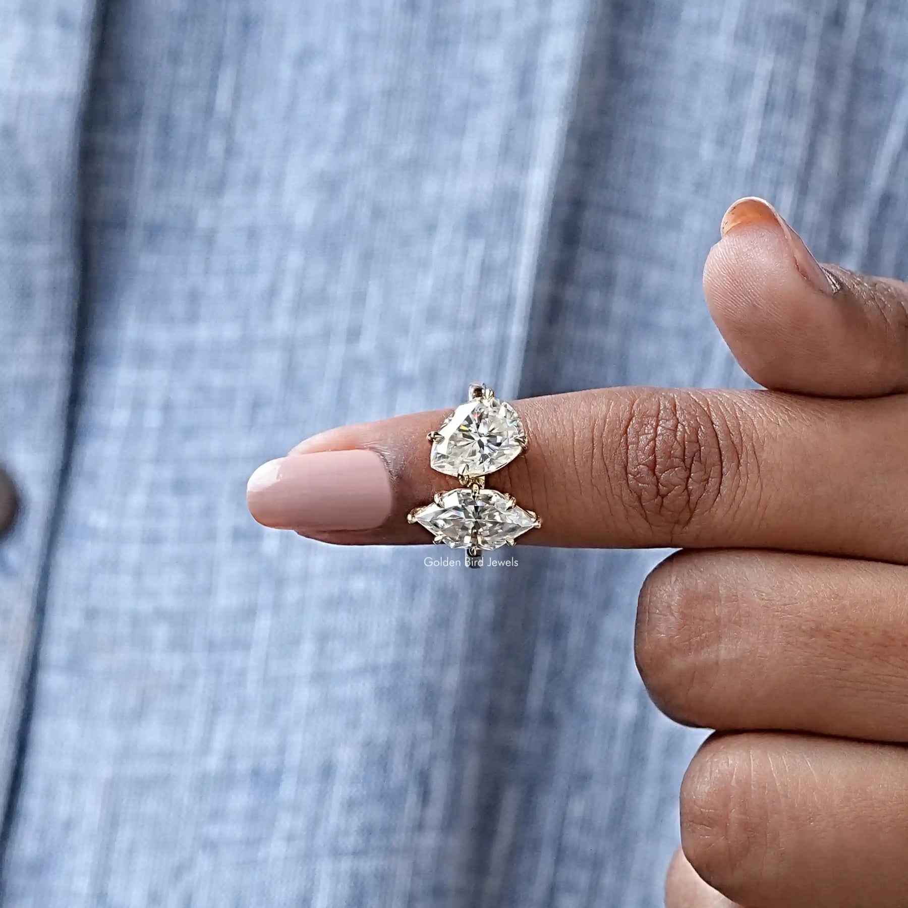 In finger front view of Dutch Marquise Cut Moissanite Toi Et Moi Ring In Yellow Gold