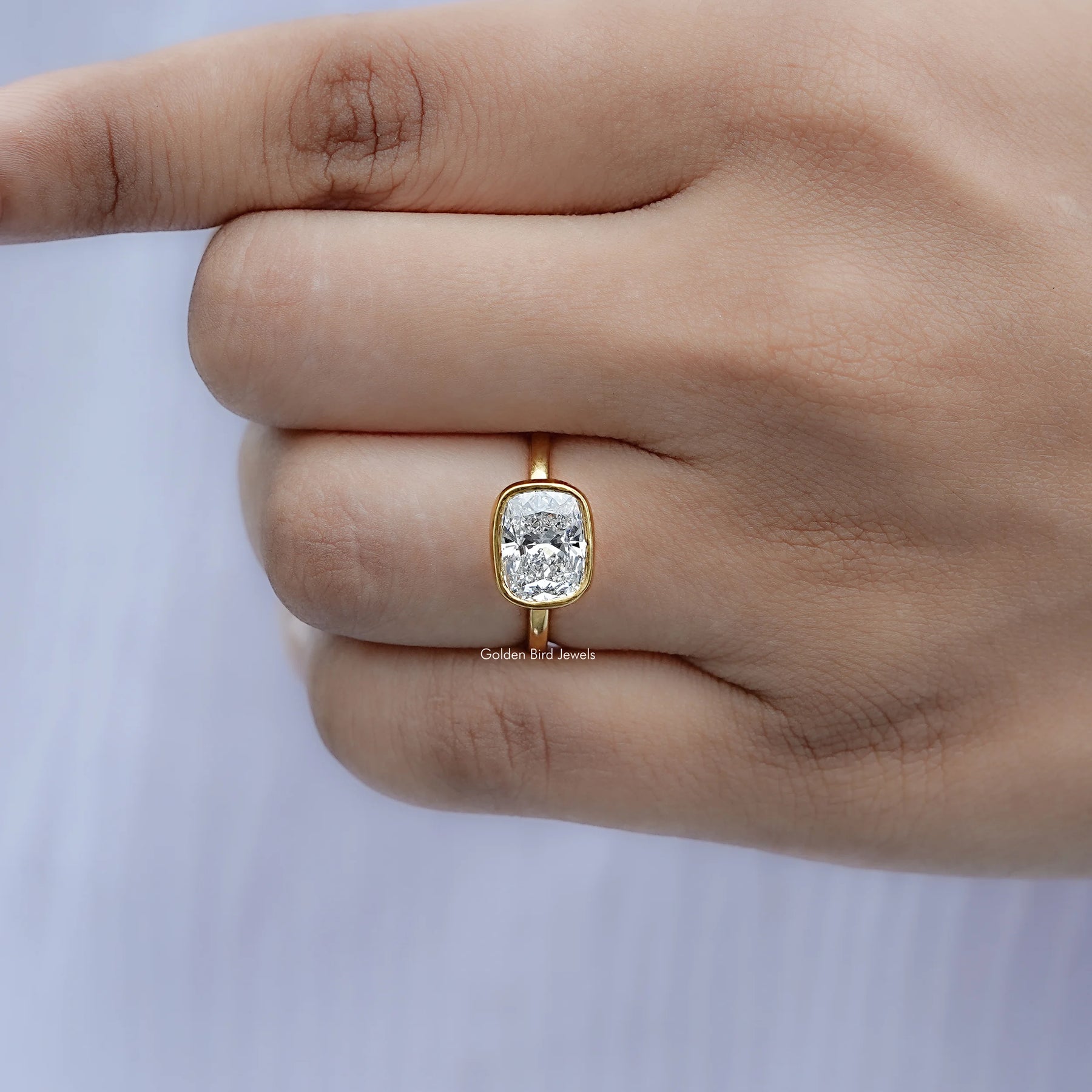 Detailed view of East West Cushion Diamond Bezel Set Ring