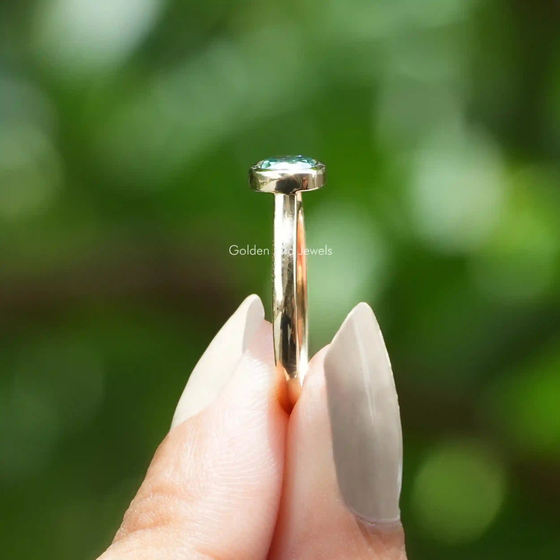 Side View of Cushion Cut Moissanite Engagement Ring In two fingers