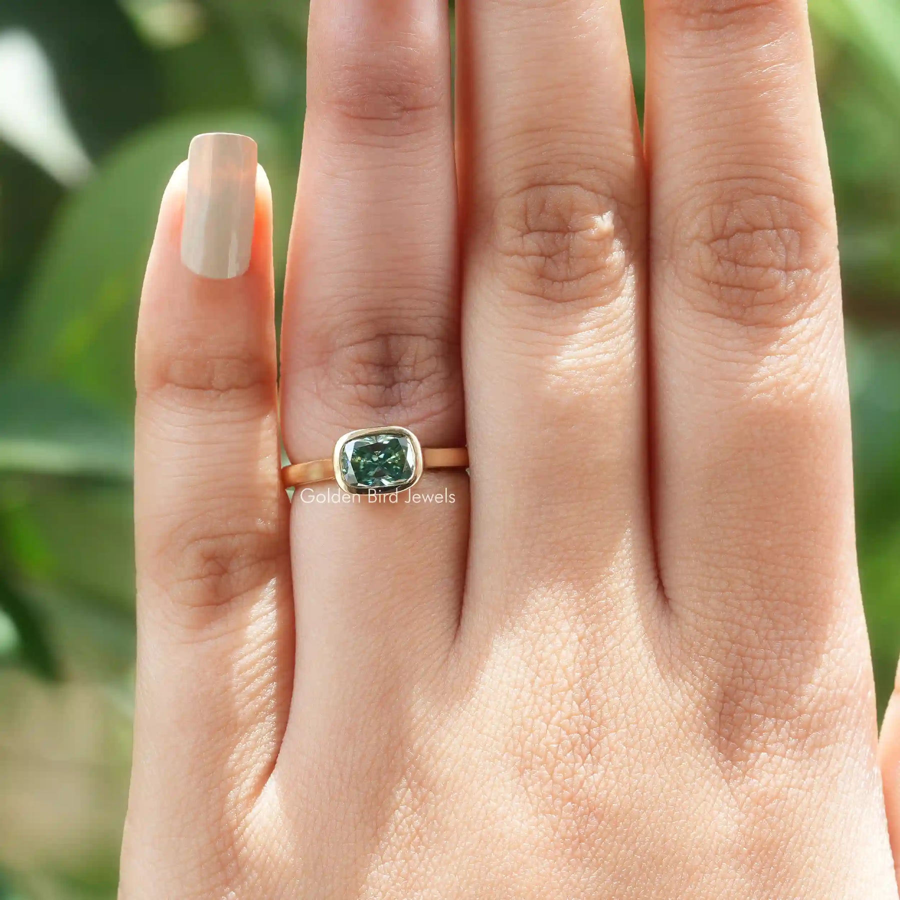 View of Cushion Cut Moissanite Bezel Set Ring In Yellow Gold