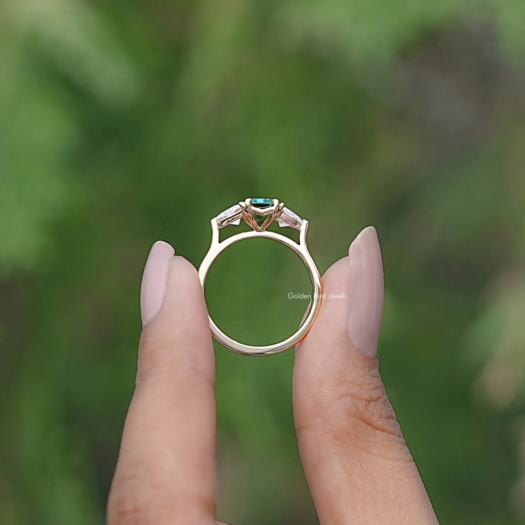 Back view of Emerald And Triangle Moissanite ring in secure setting