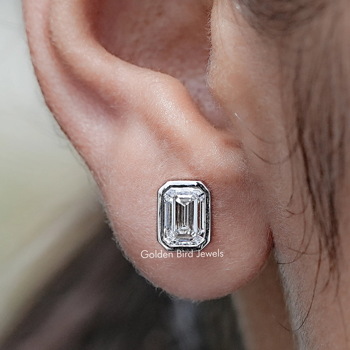 Close up view of Emerald Cut Lab Diamond Bezel Set Stud Earrings