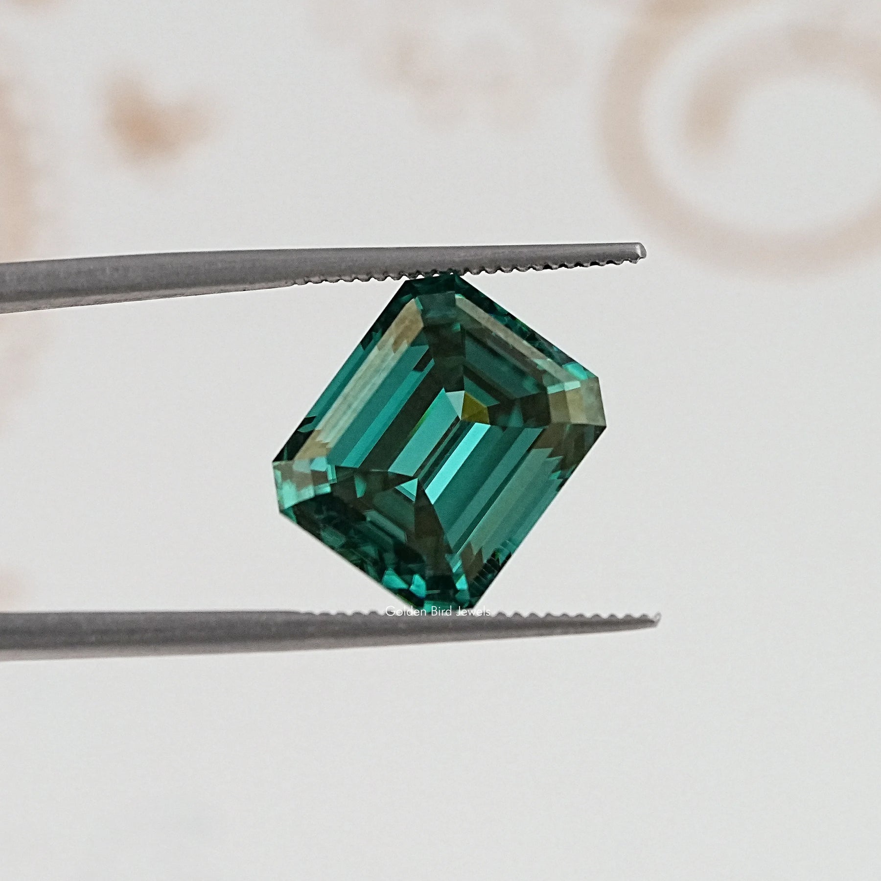 In Tweezer View Of Old Mine Emerald Cut Loose Moissanite Stone