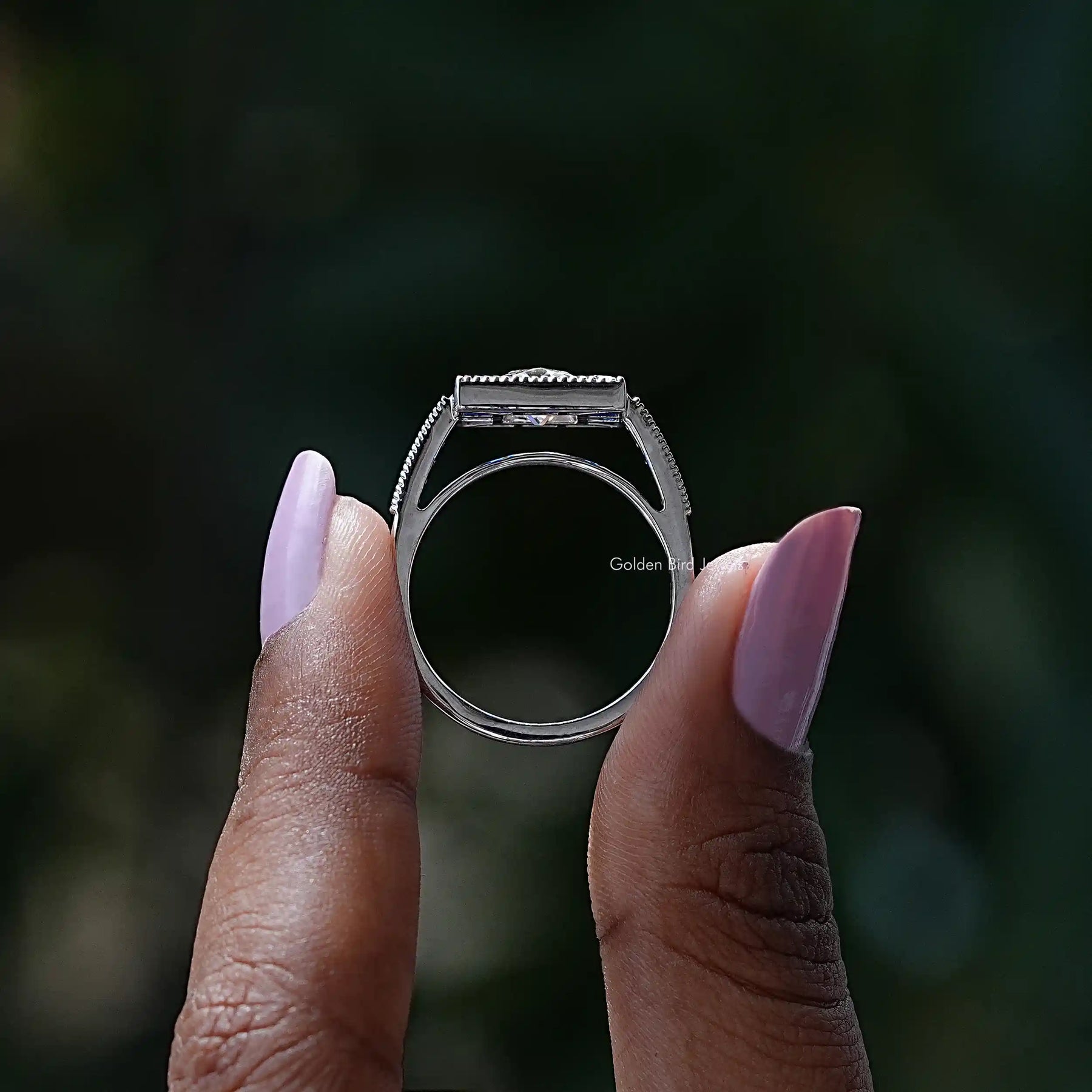 Back View of Radiant And Baguette Cut Halo Moissanite Ring In two fingers
