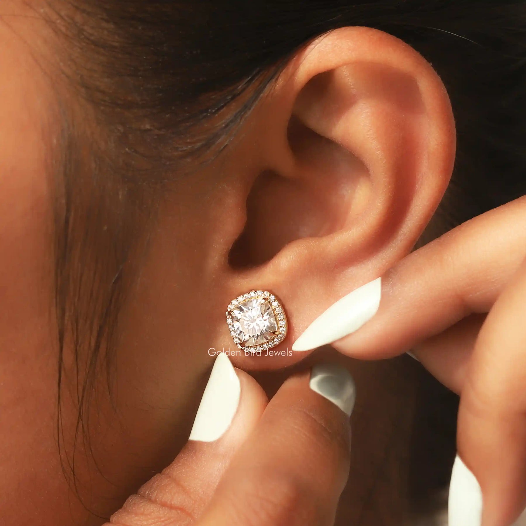 Front view of round cut side stones moissanite stud earrings