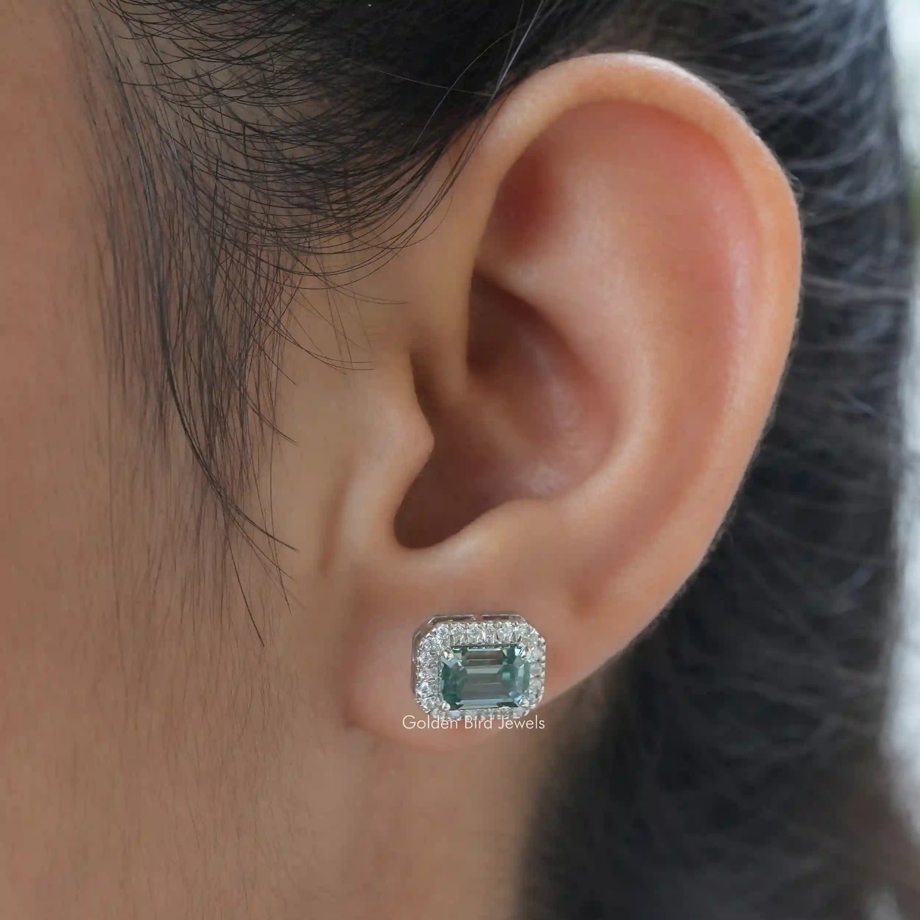 In ear front view of emerald cut stud earrings for women's wear