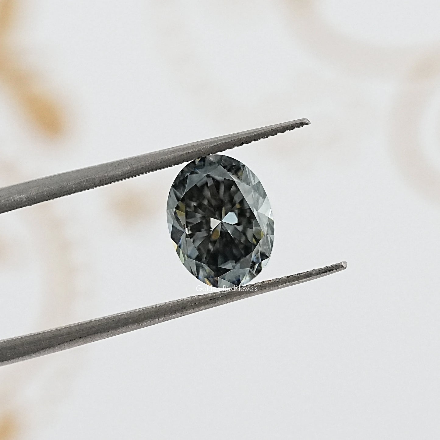 tweezers View of Gray Oval Cut Moissanite