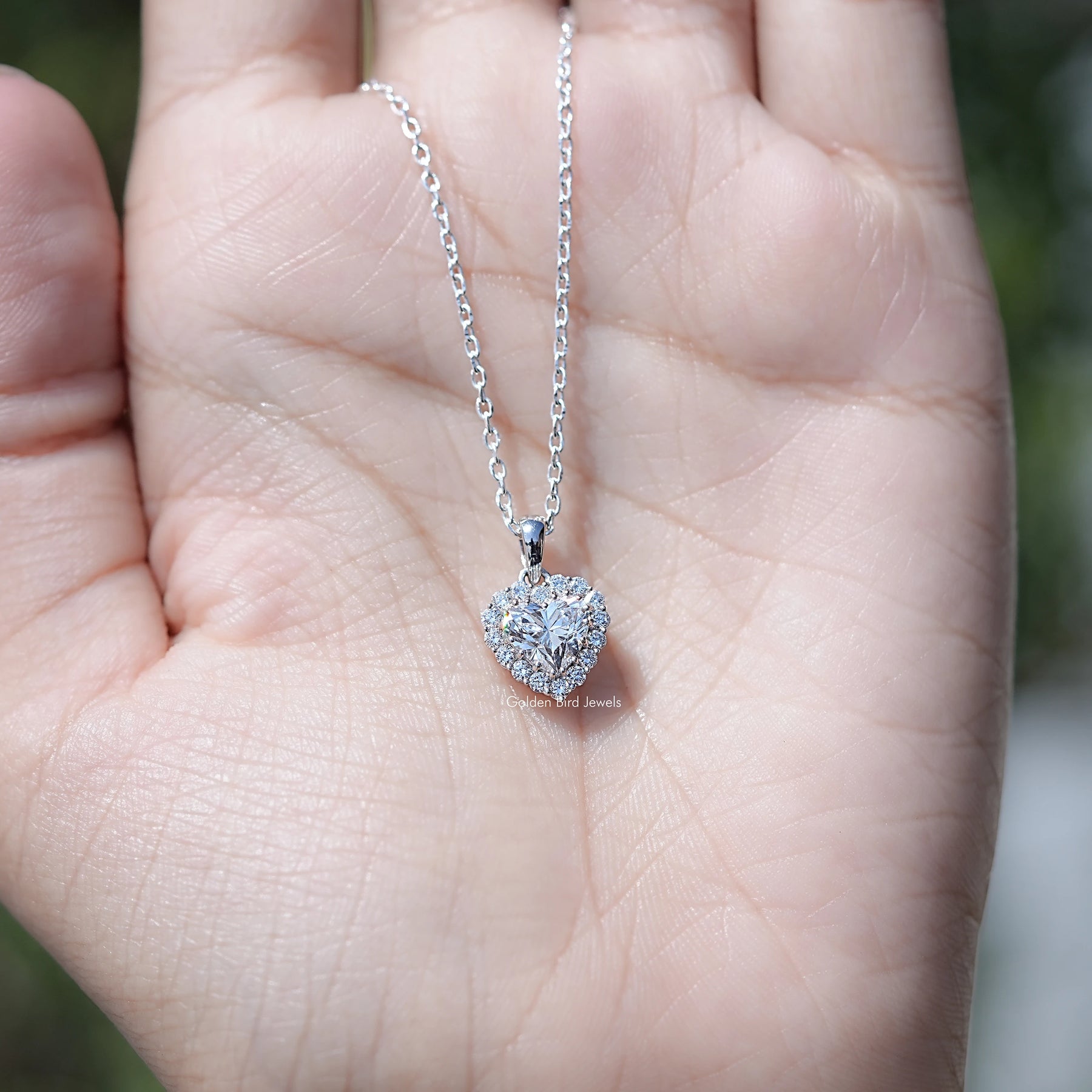 In Hand Showing of Halo Pendant In Heart Shaped Diamond Necklace