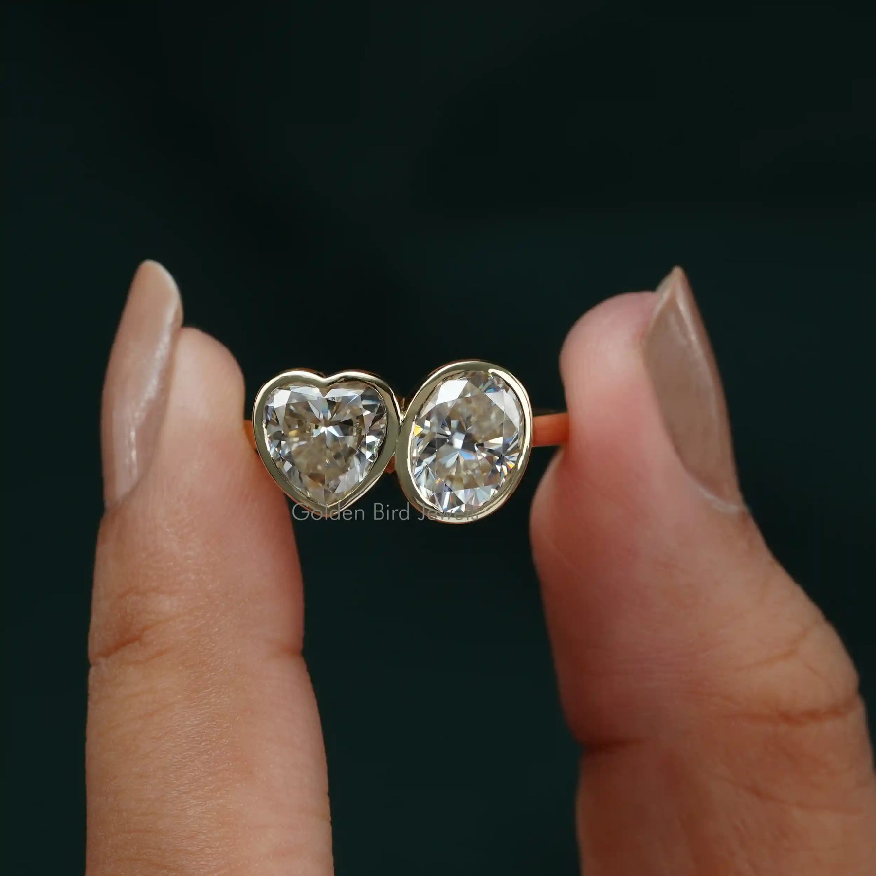 Front View of Oval And Heart Cut 2 Stone Ring In 18k Yellow Gold In two Fingers