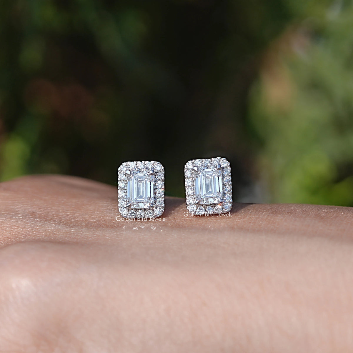 In Hand Front View Of Emerald Cut Diamond Stud Earring In White Gold