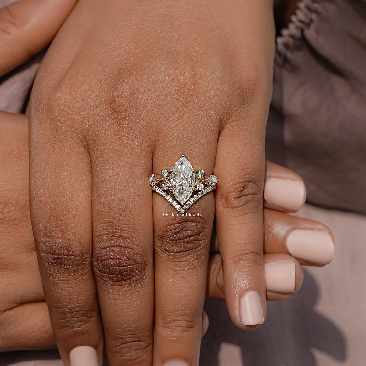 Gold-tone marquise cut cluster engagement ring with sparkling side stones