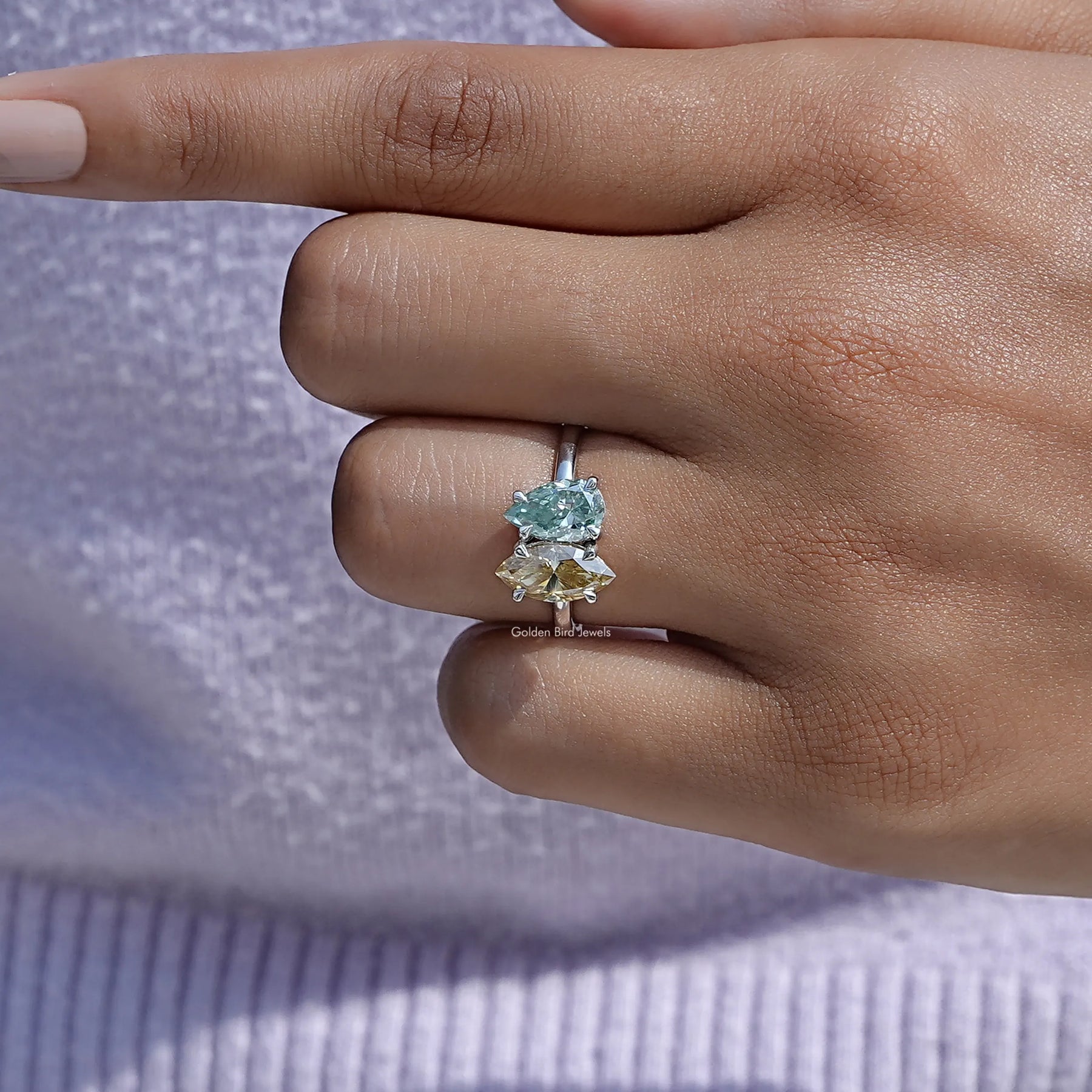 Detailed view of moissanite marquise and pear cut wedding ring