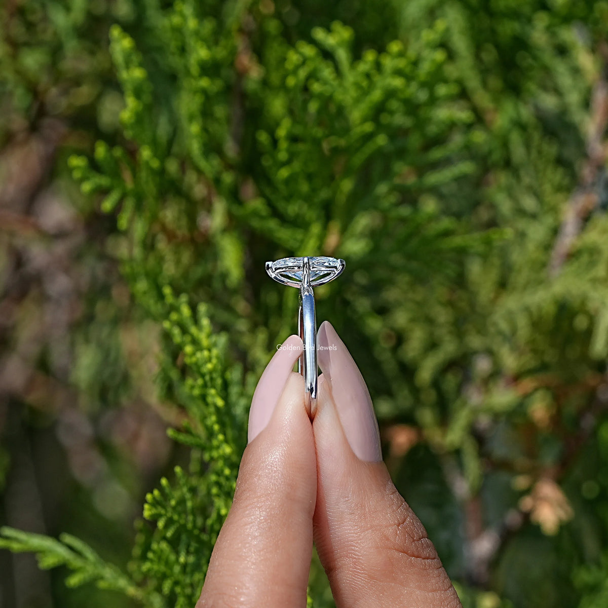Side View of Marquise Cut  Solitare Ring in two fingers