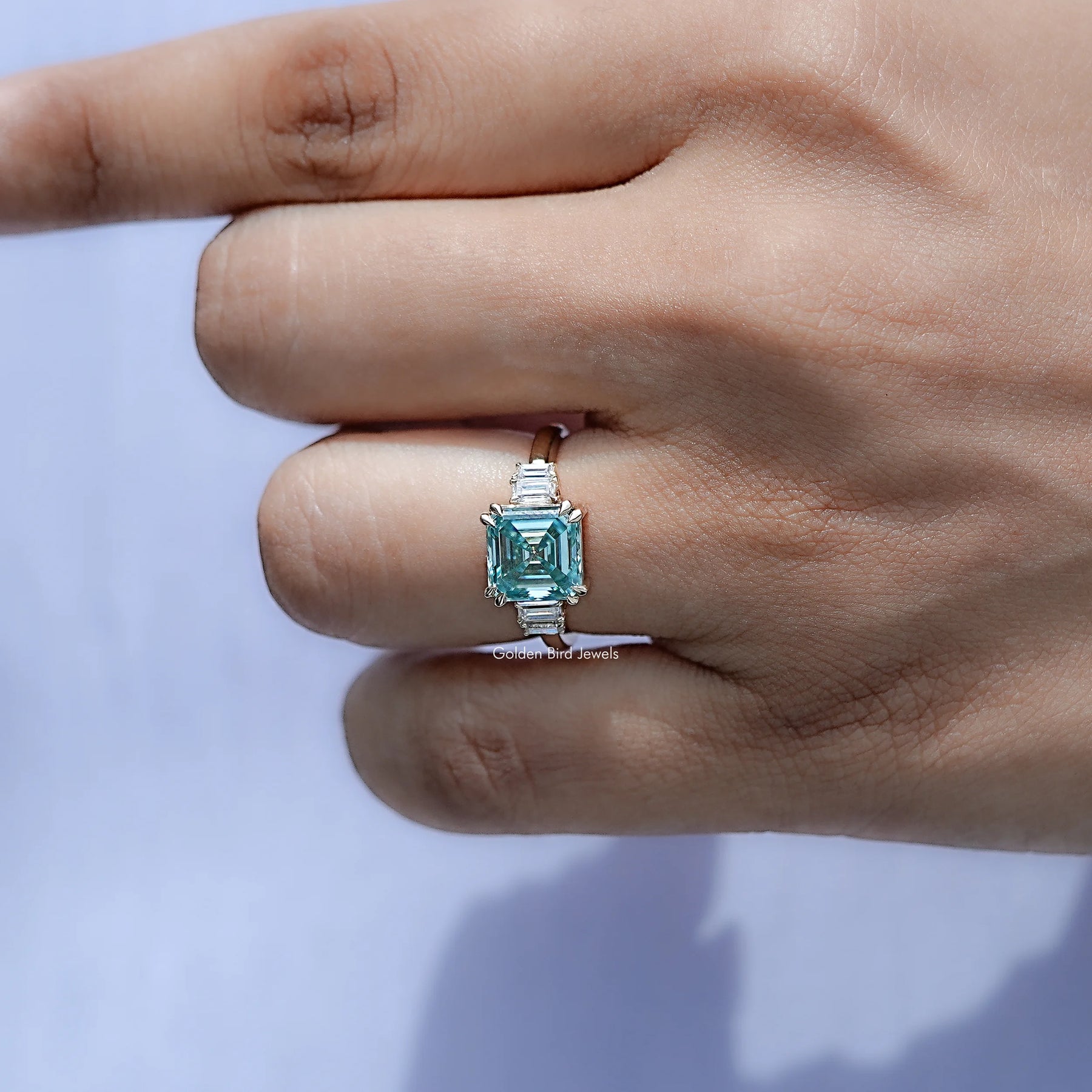 In finger front view of Asscher Cut Moissanite Five Stone Engagement Ring in unique shape