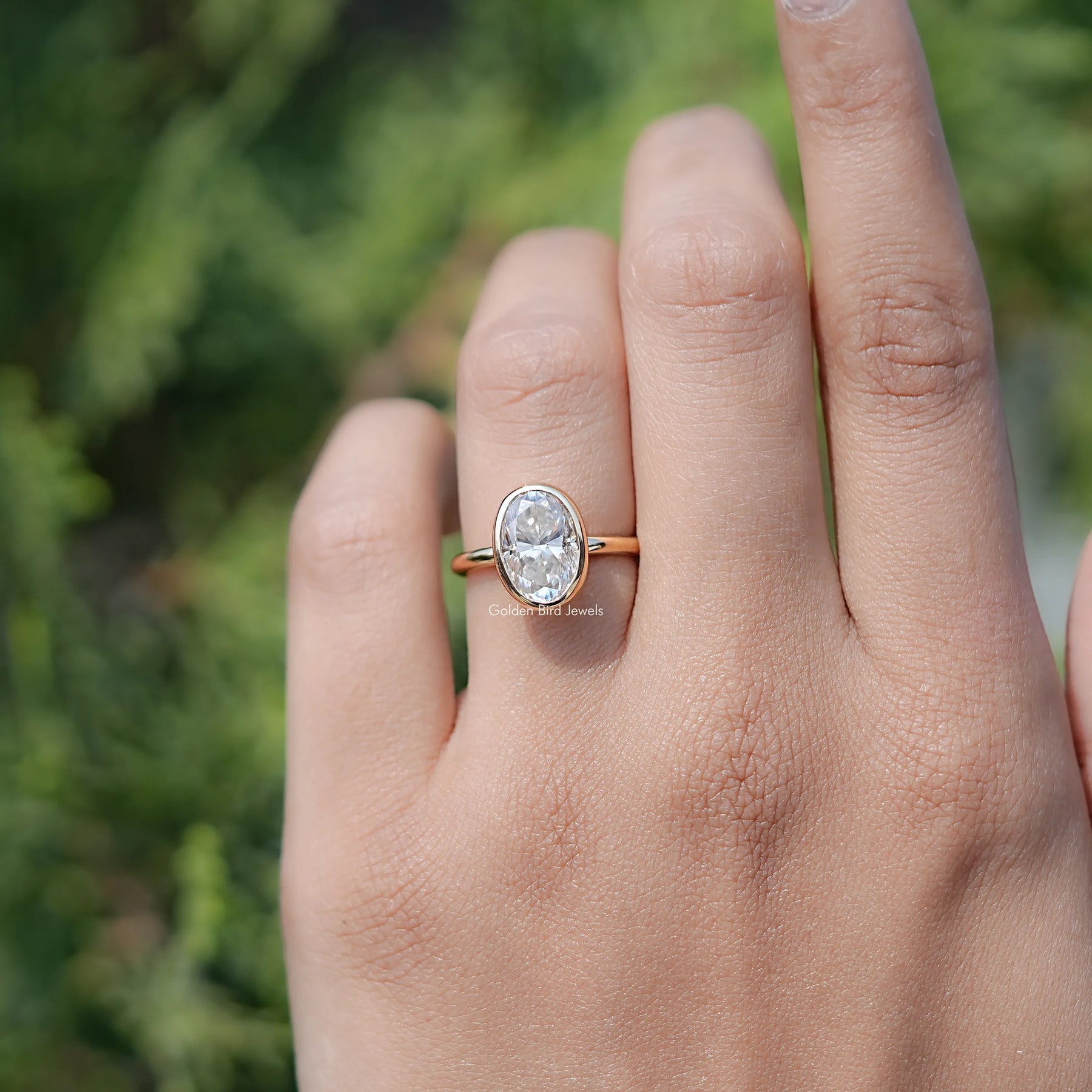 In finger view of Oval Moissanite Halo Engagement Ring