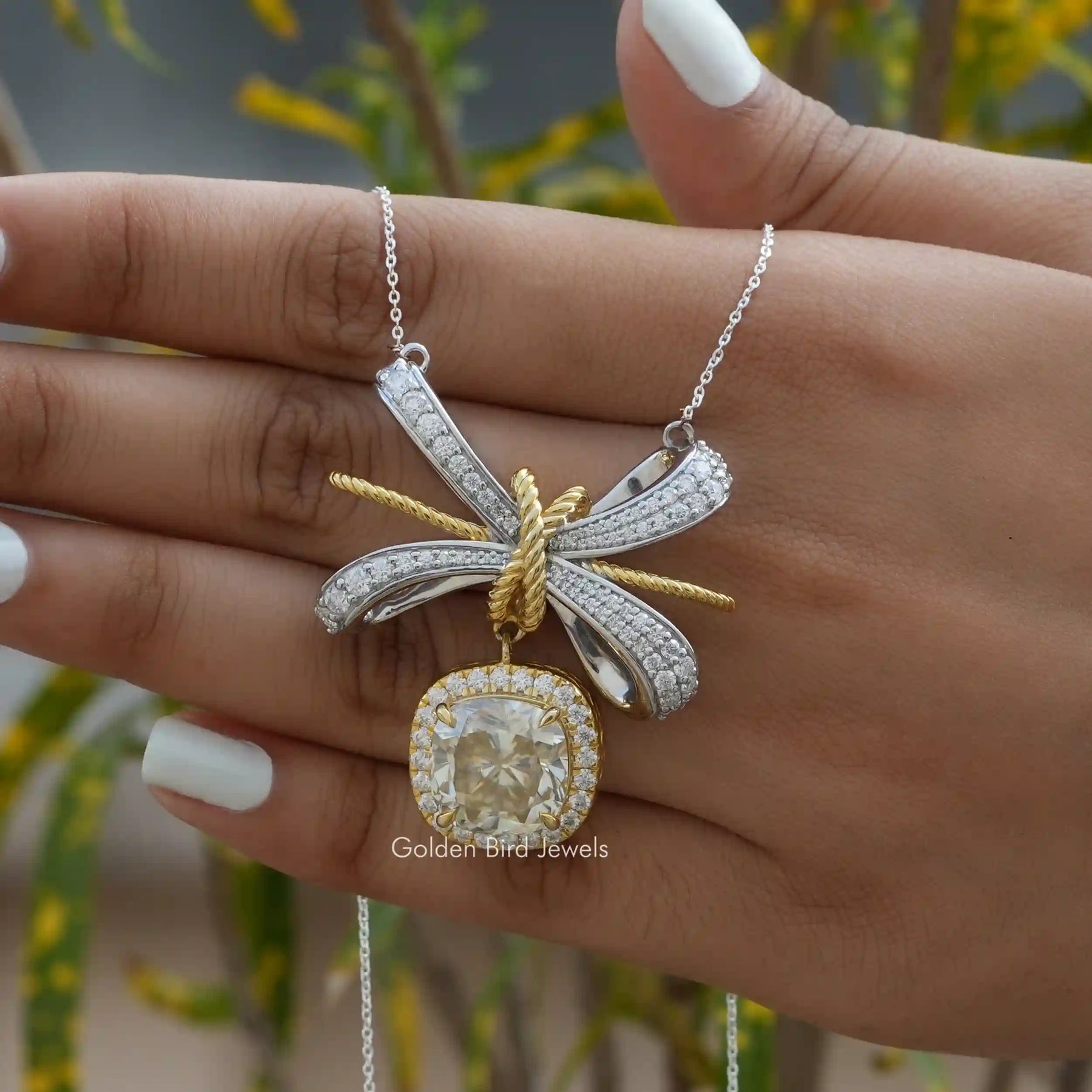 In hand showing view of moissanite pendant