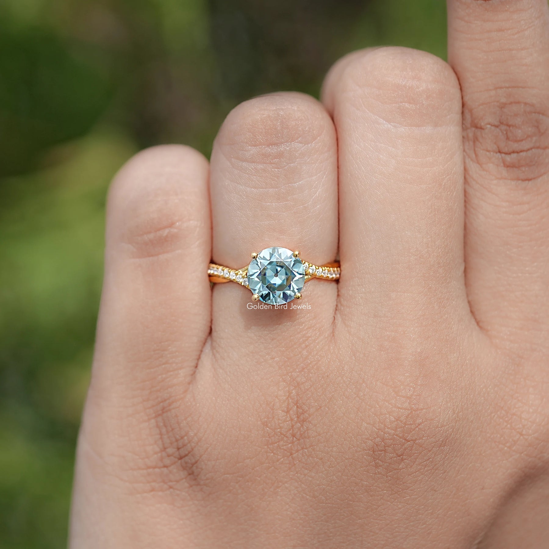 In finger view of Round Cut Moissanite Engagement Ring