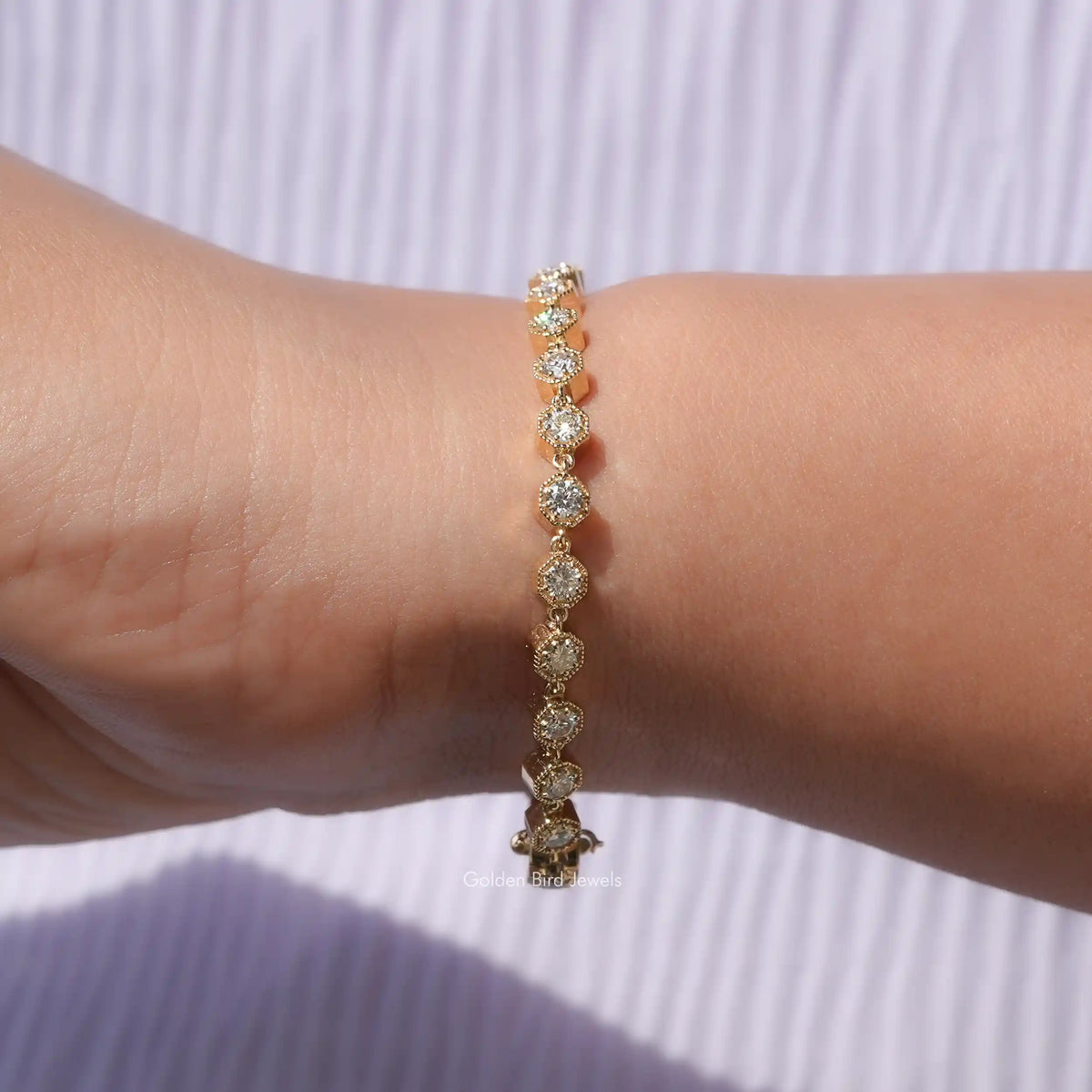 In hand view of round cut moissanite halo bracelet