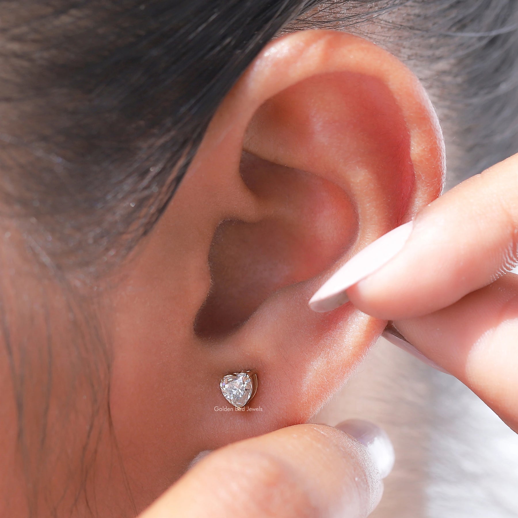 Front view of heart cut moissanite stud earrings in  yellow gold