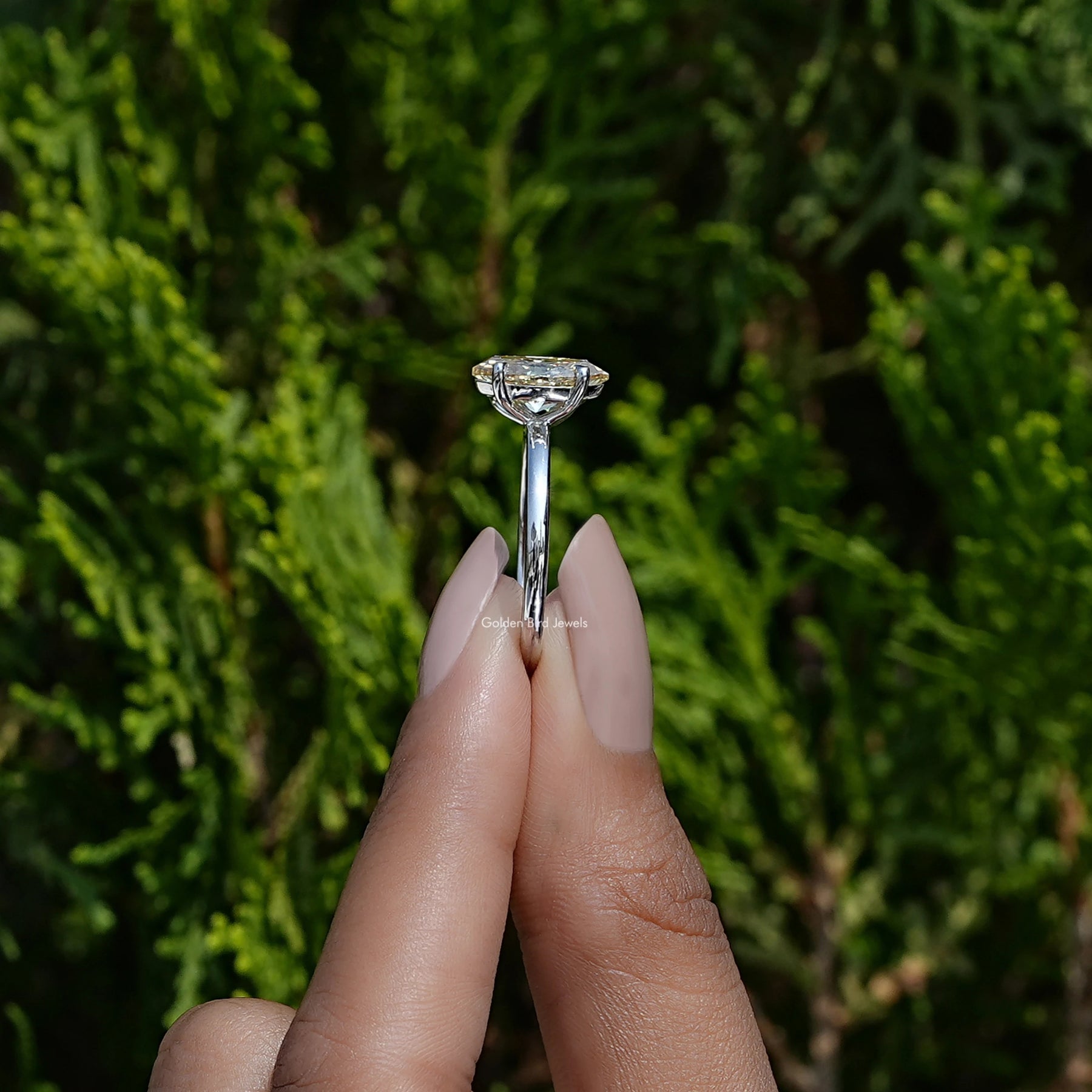 Side view of marquise and pear cut moissanite Ring in white gold
