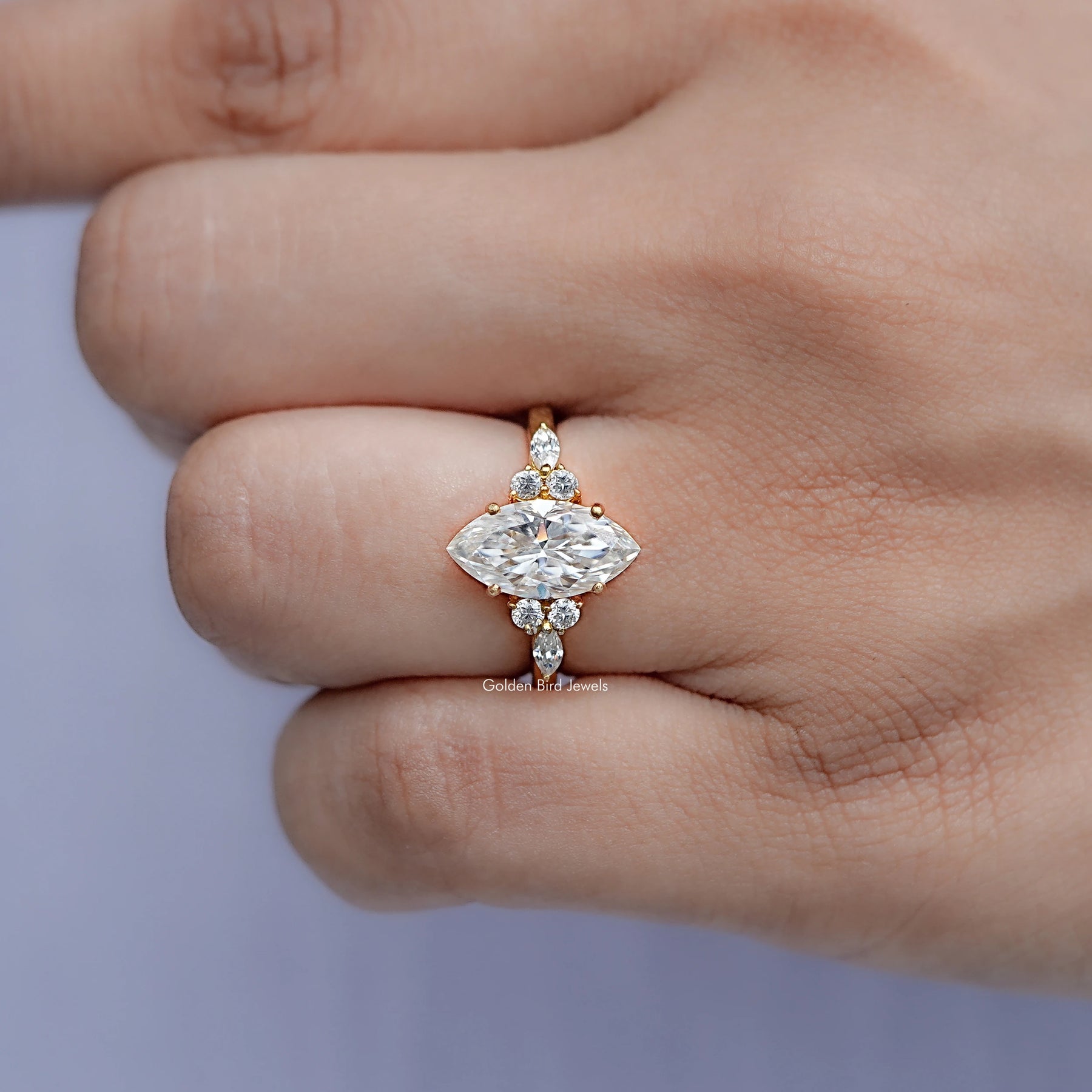 In finger front view of Marquise Cut Moissanite Accent Stone Ring in unique shape
