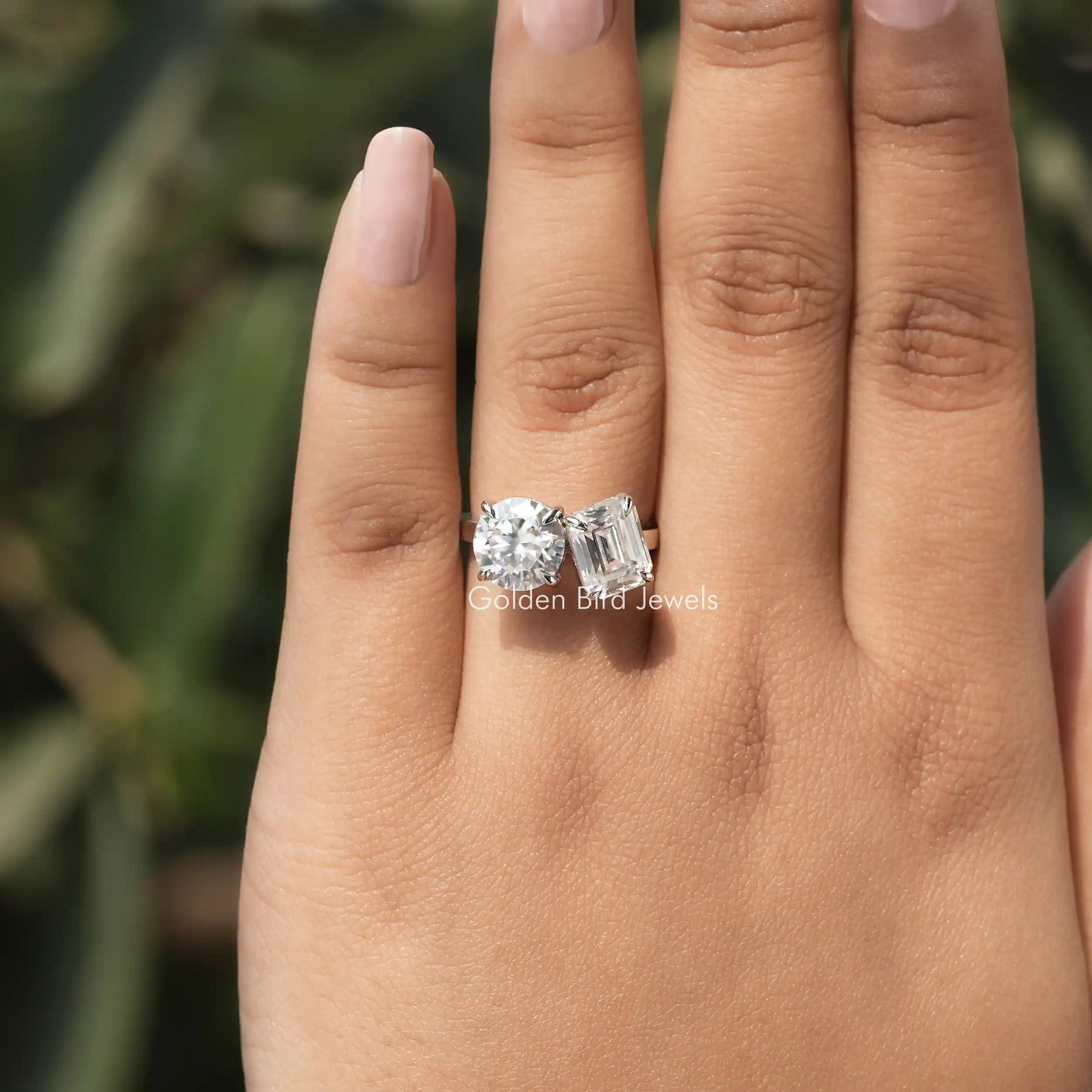 View of Toi Et Moi Emerald And Round Cut Ring In Finger