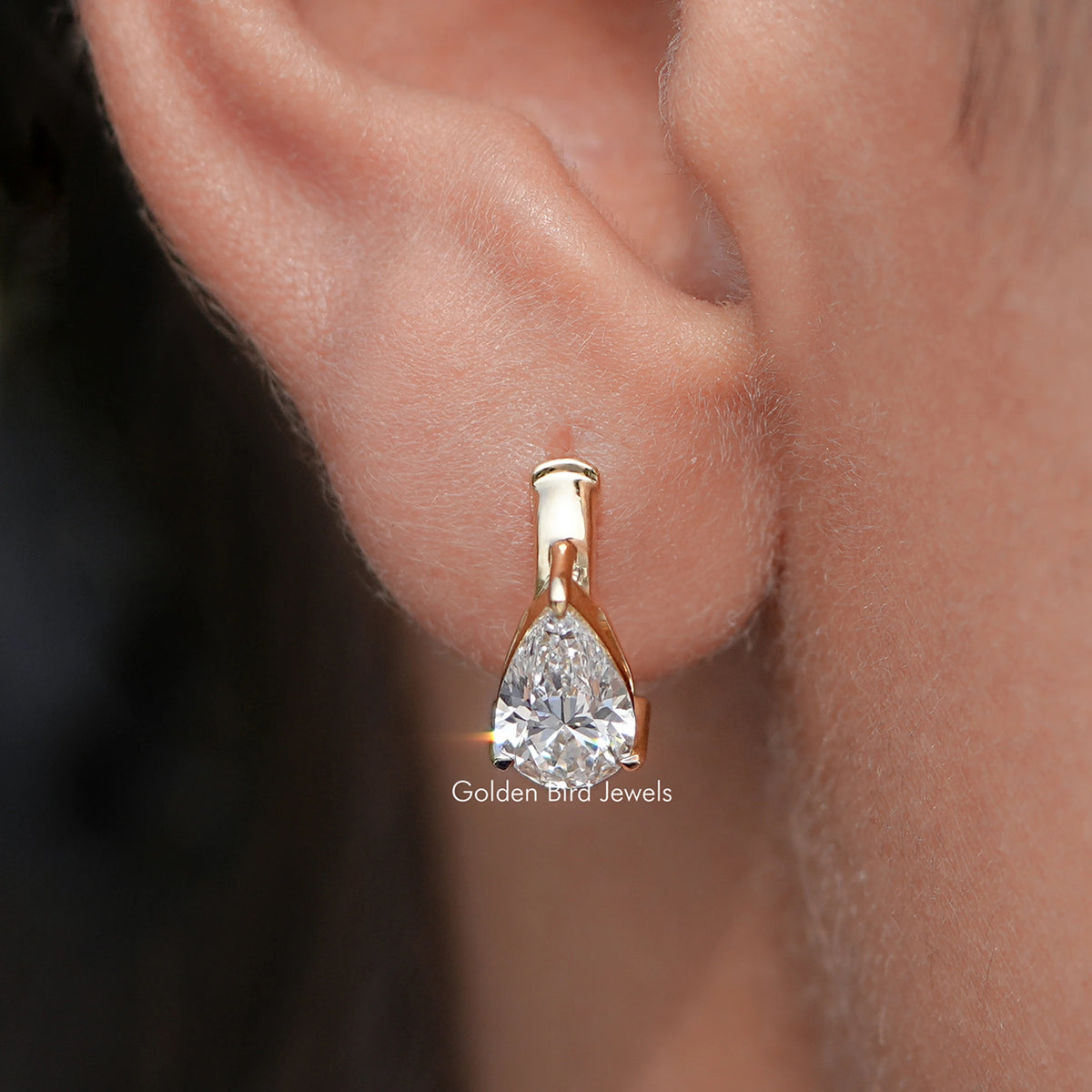 Close Up View Of Pear Cut Lab Diamond Solitaire Huggie Hoop Earrings