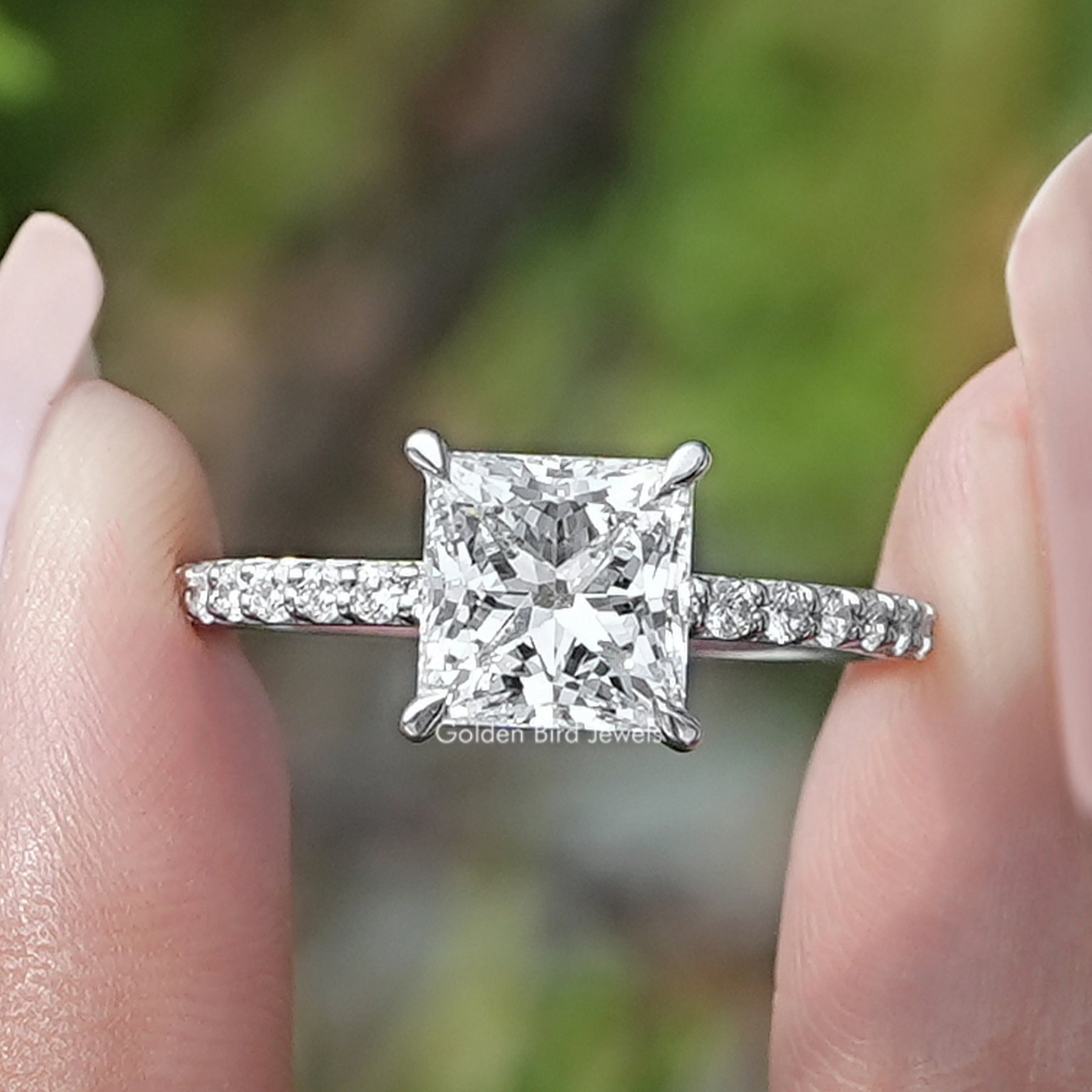 Princess Cut Lab Diamond Solitaire Accent Ring Held Between Fingers