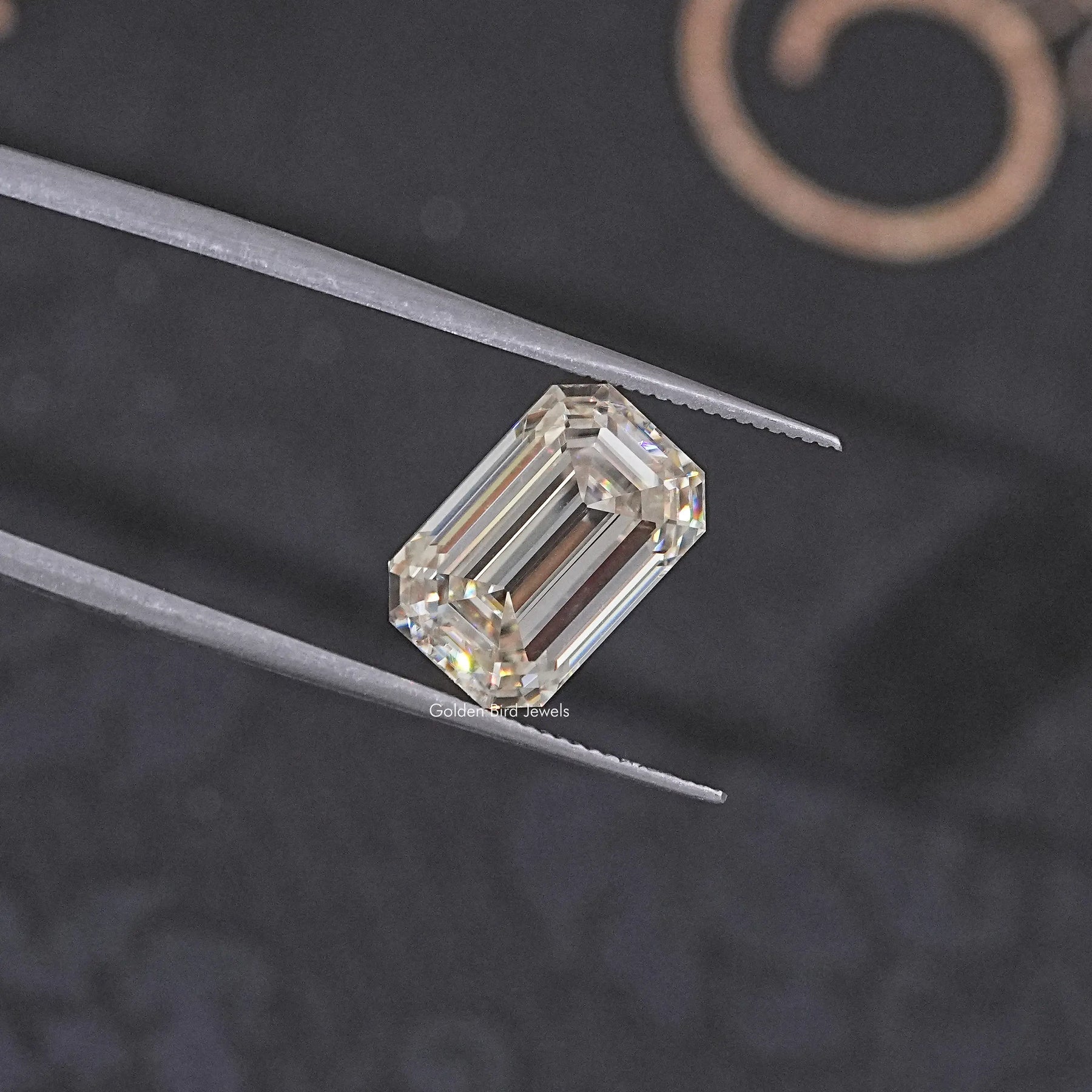 In Tweezer View Of Old Mine Emerald Cut Loose Moissanite Stone