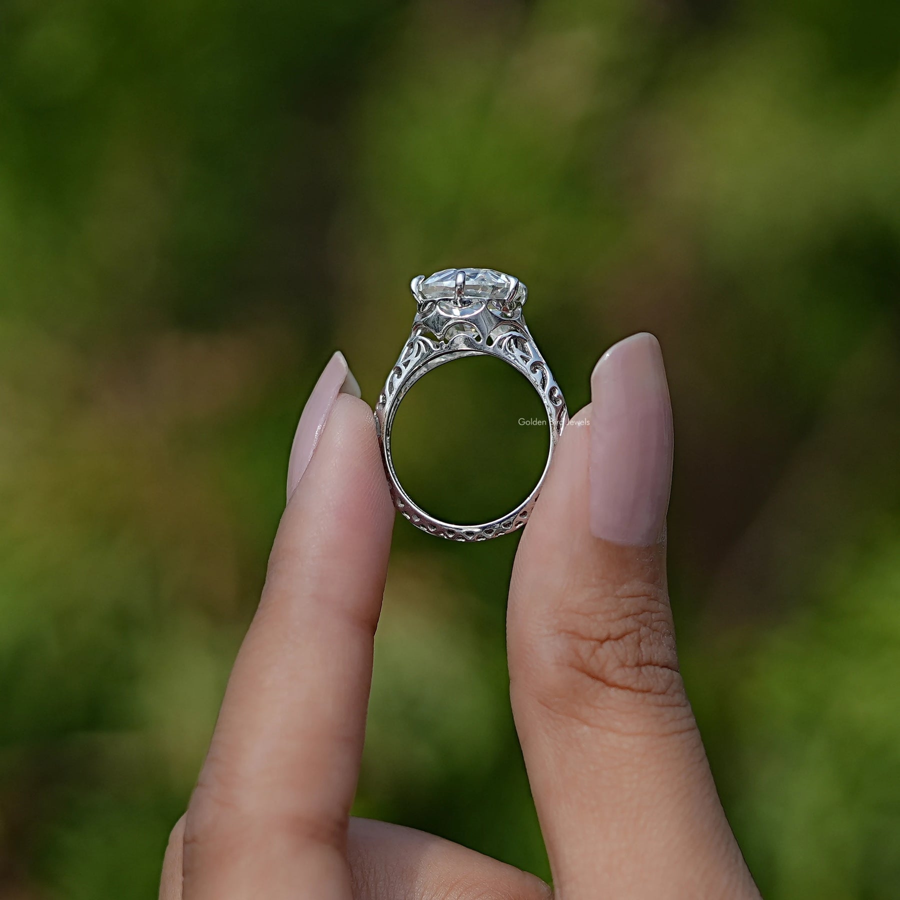 Back View of Old European Cut Round Moissanite Vintage Ring In two fingers