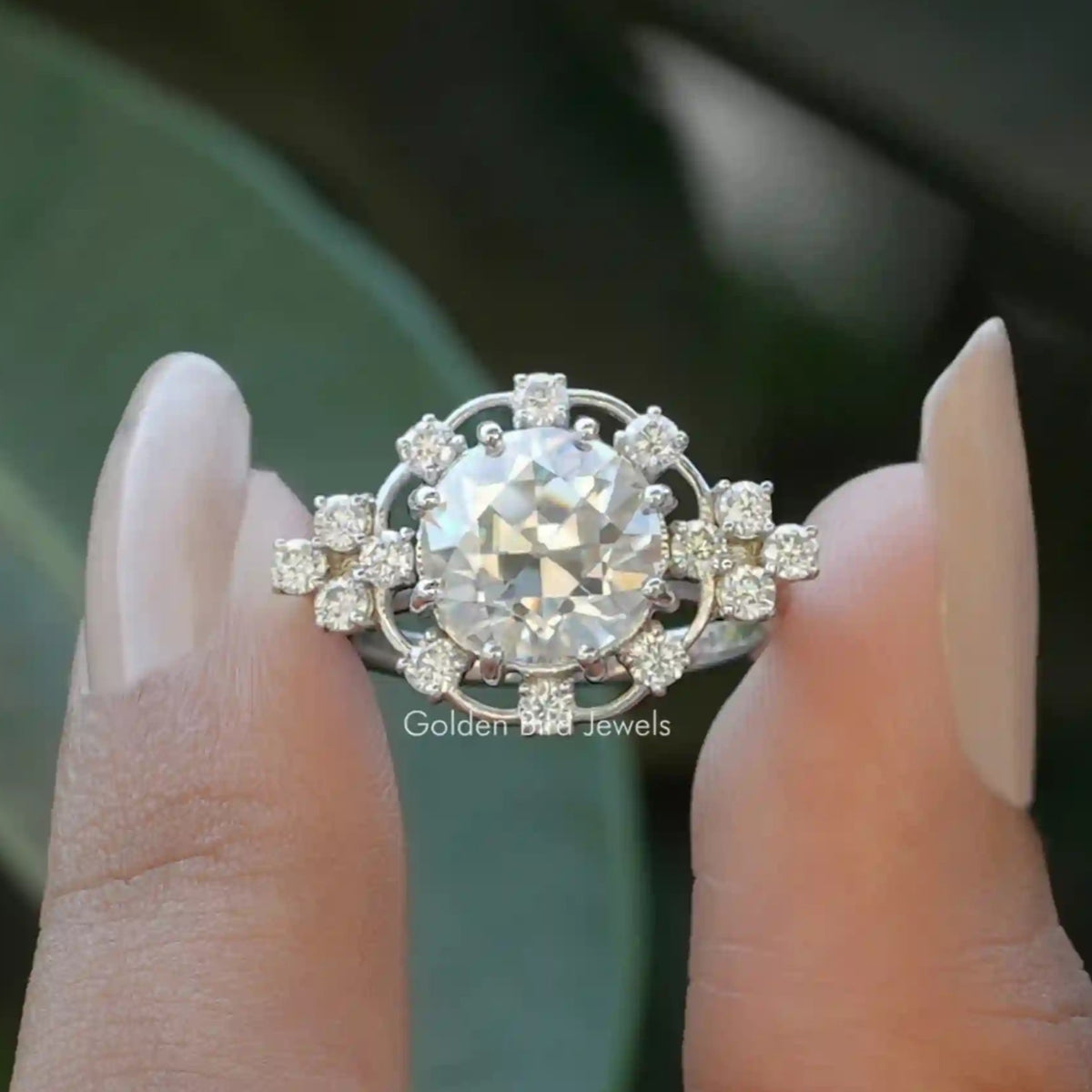 Front View of Old European Round Cut Moissanite Proposal Ring In two Fingers