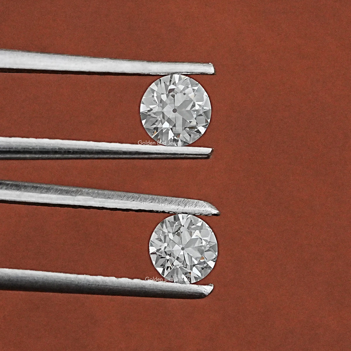 Tweezer holding the Old European Round Diamond Matching Pair