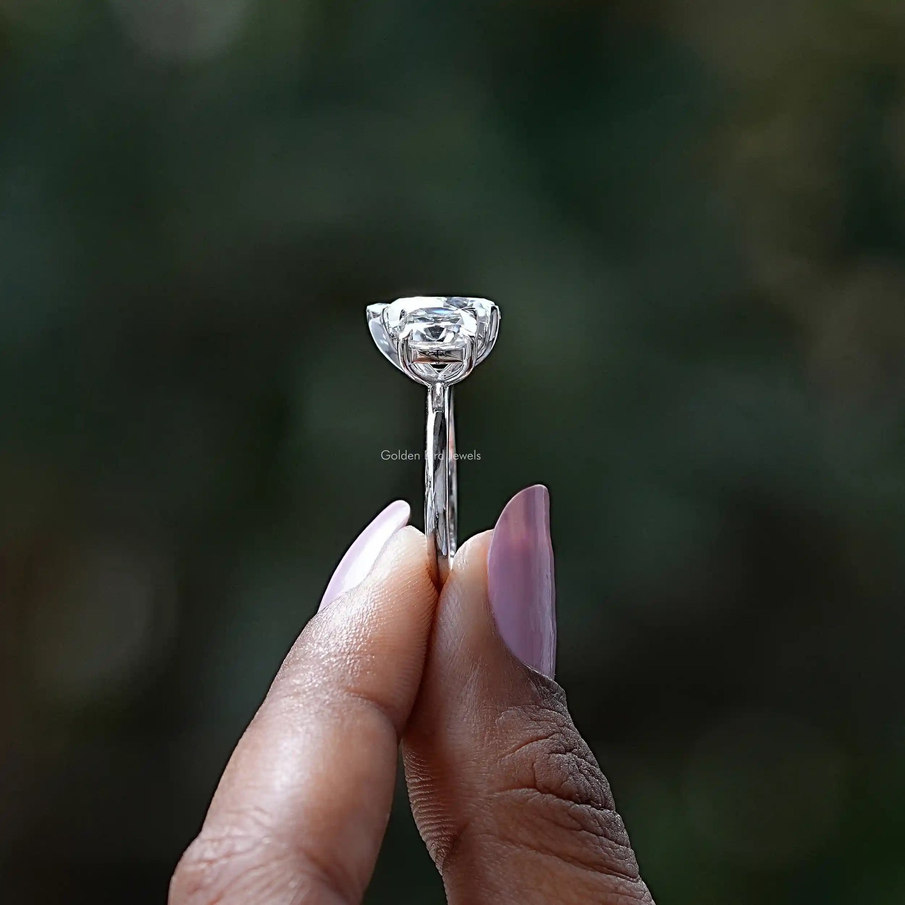 Side View of Old Mine Cushion Cut Moissanite Ring In two fingers