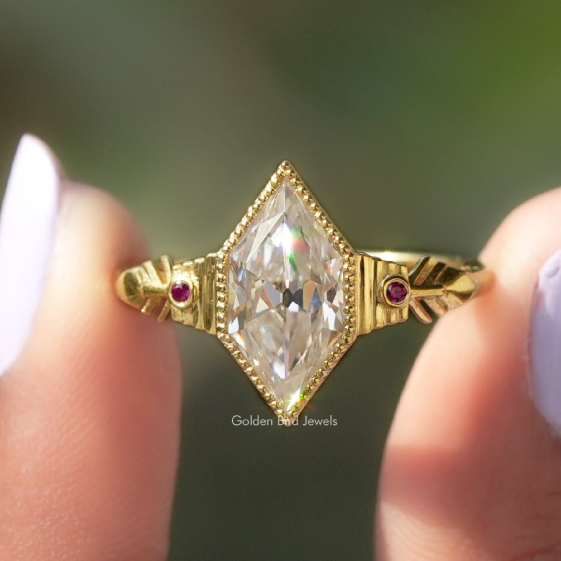 Two fingers holding the old mine dutch marquise cut moissanite ring