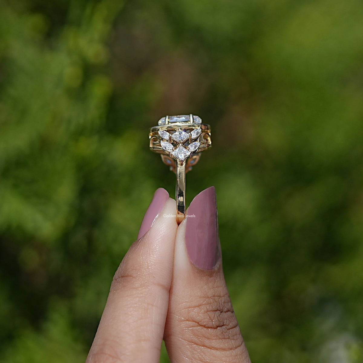 Side View of Moval Cut Moissanite Halo Cluster Engagement Ring In two fingers