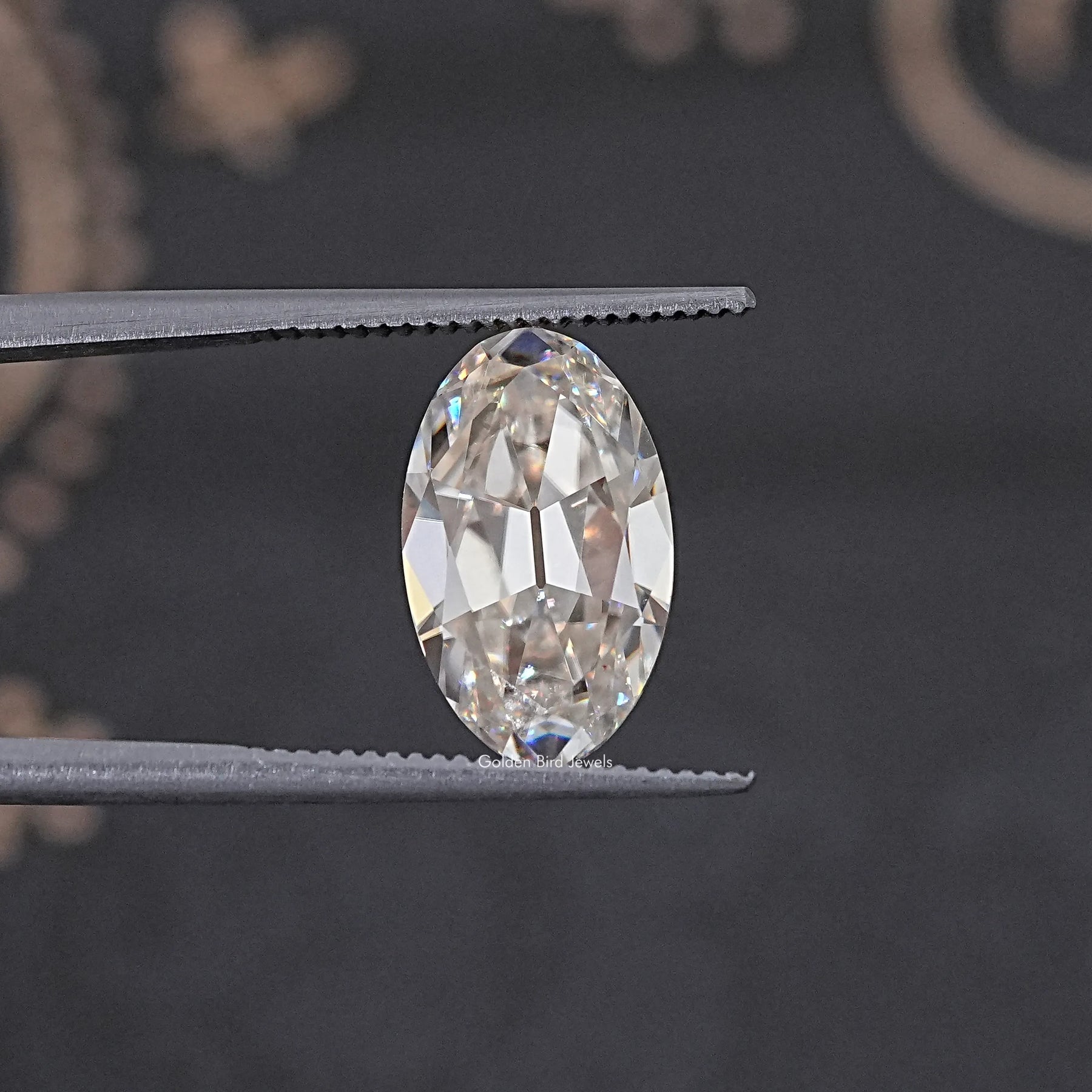 In Tweezer View Of Old Mine Oval Cut Loose Moissanite Stone