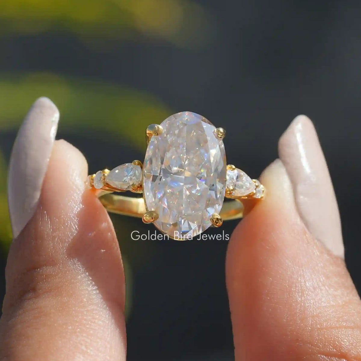 Front View of Oval Cut Moissanite Engagement Ring In two Fingers