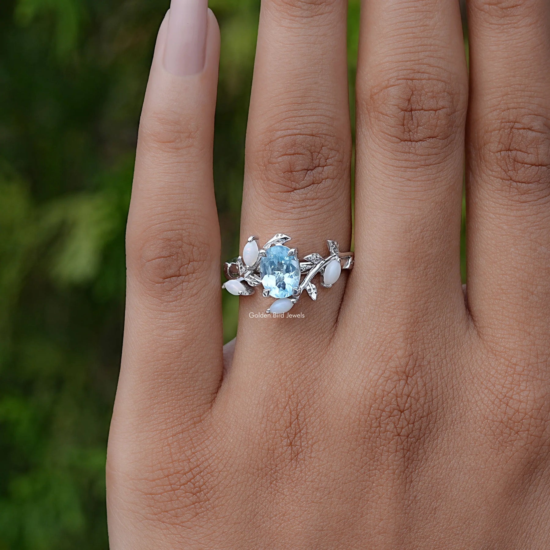 Detailed View Of Oval Cut Gemstone Leaf Style Accent Ring In Yellow Gold