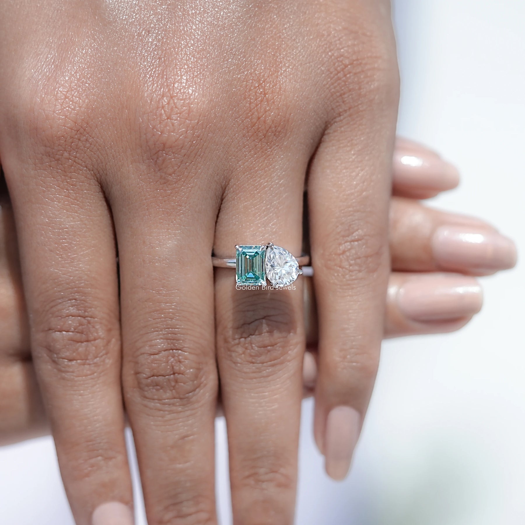 Close view of Pear And Emerald Cut Moissanite Solitaire Ring