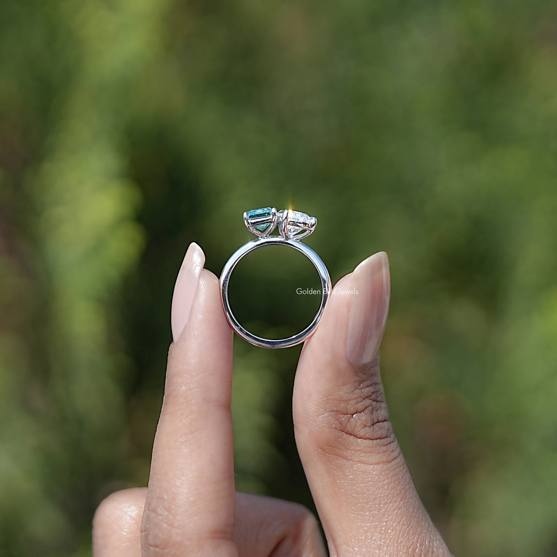 Back view of Pear And Emerald Cut Moissanite Solitaire Ring in secure setting