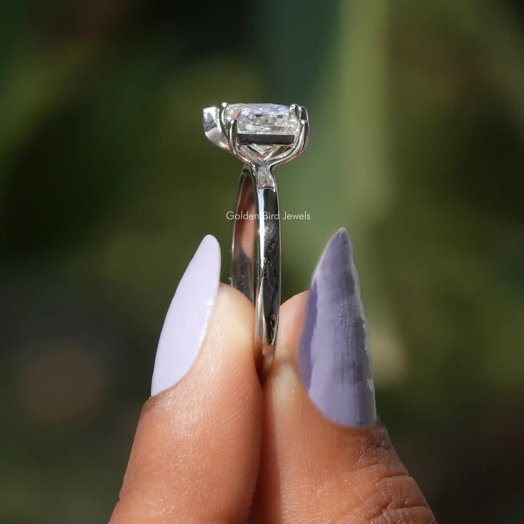 Side View of Toi Et Moi Pear And Princess Cut Ring In two fingers