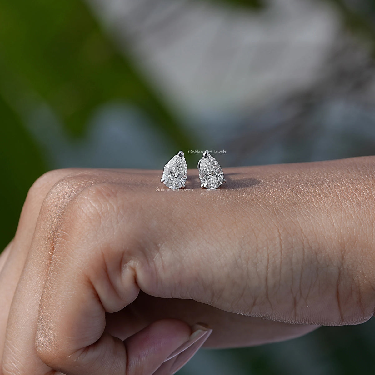 In Hand View Of 2CTW pear Cut  Solitaire Stud Earring