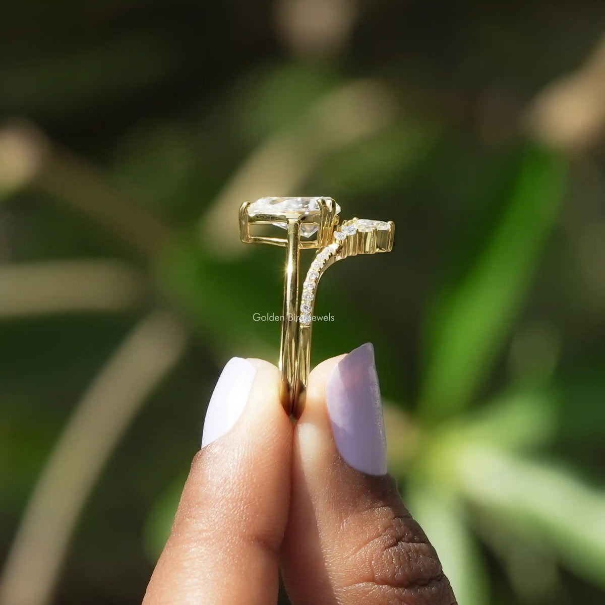 Side View of Pear Cut Moissanite Bridal Ring Set In two fingers