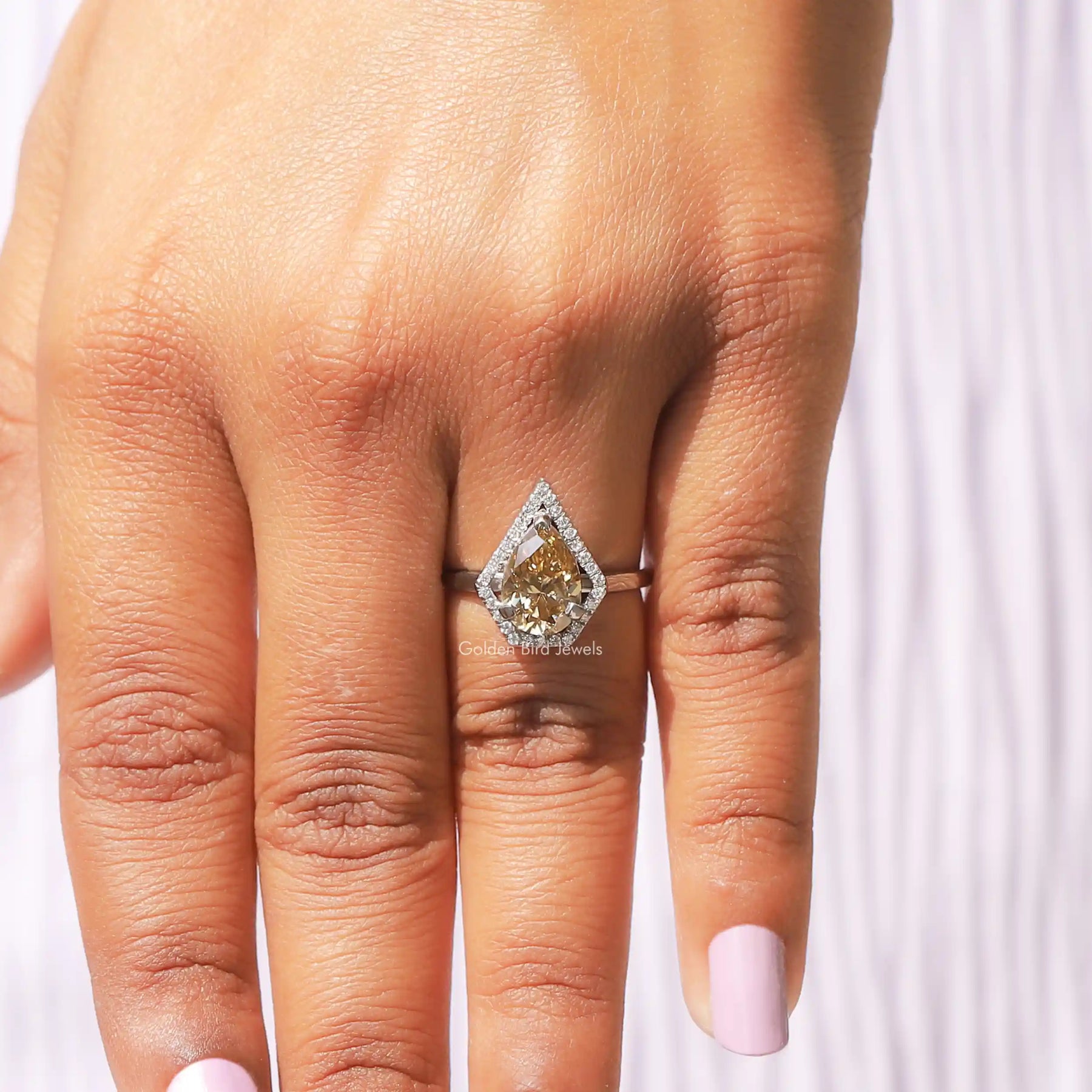 View of Pear Shaped Halo Moissanite Ring In finger